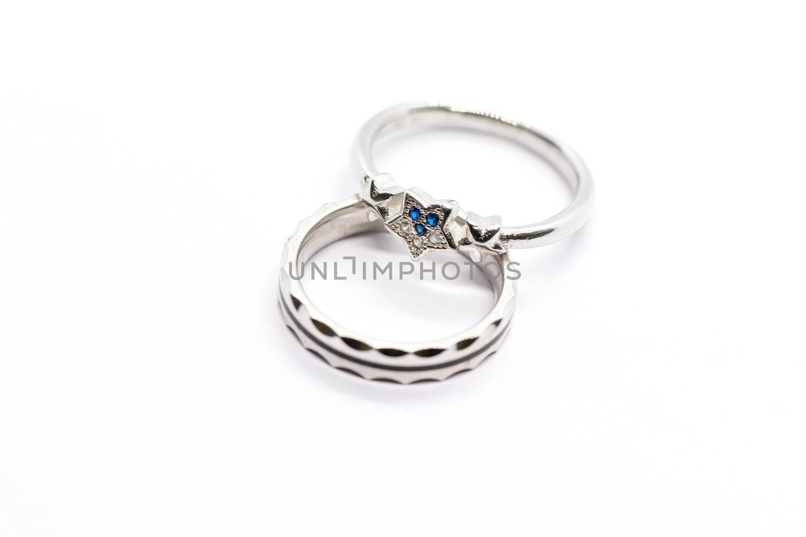 silver ring design with blue stone on white background