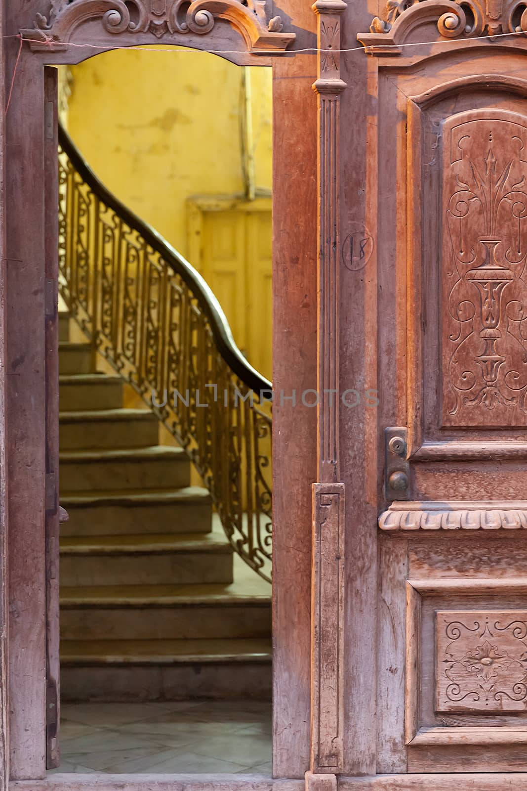Beautiful ornate open old wooden door and staircase in Havana, Cuba. Symbol of opportunities