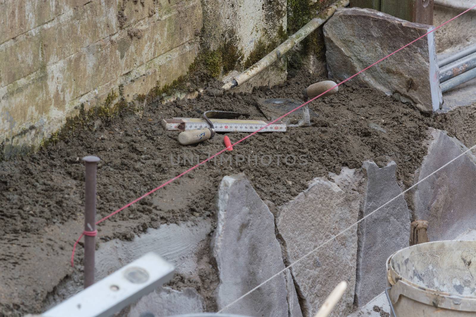 Workers at the laying and clipping of natural stone plates