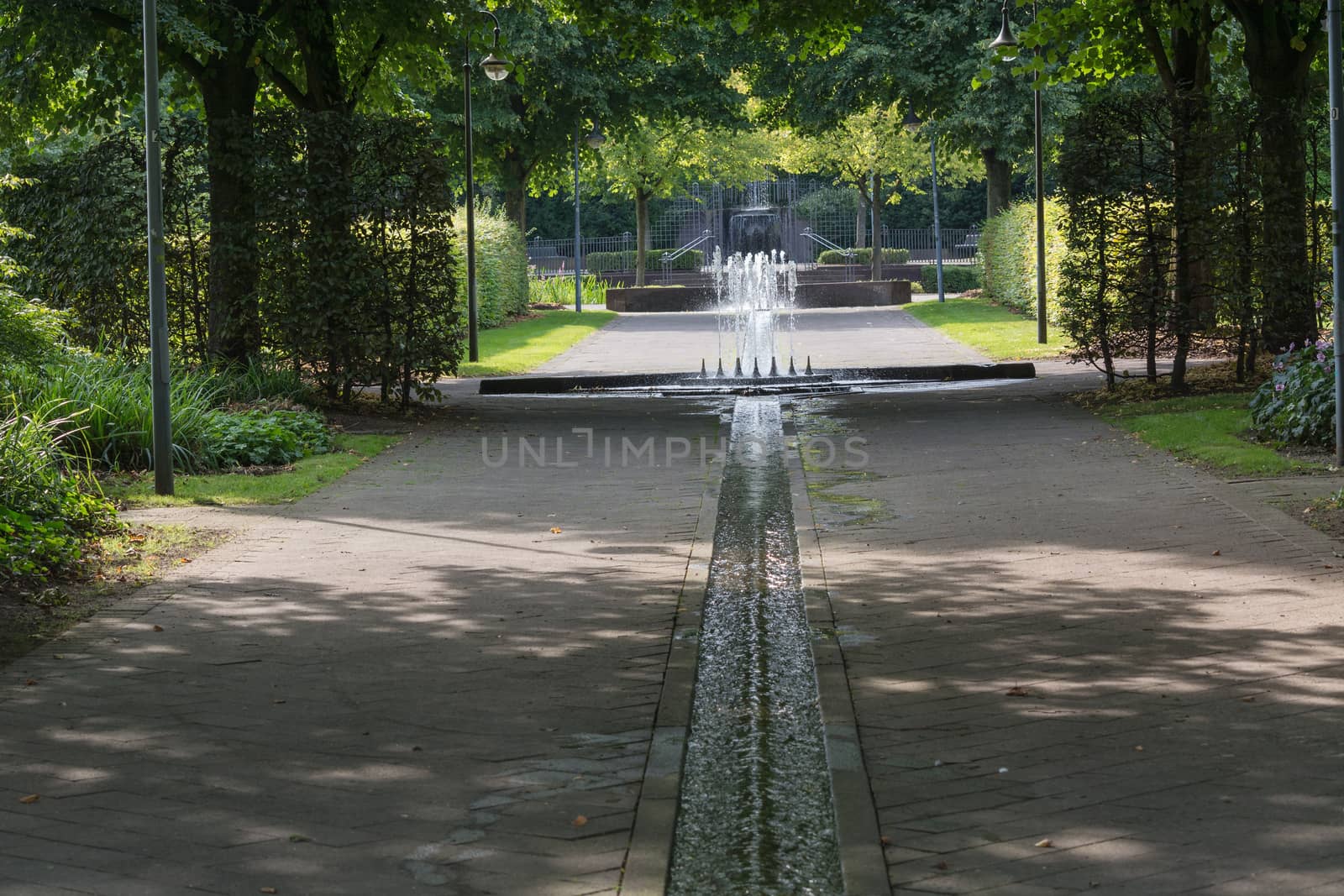 Small weir waterfall fountain in a public park