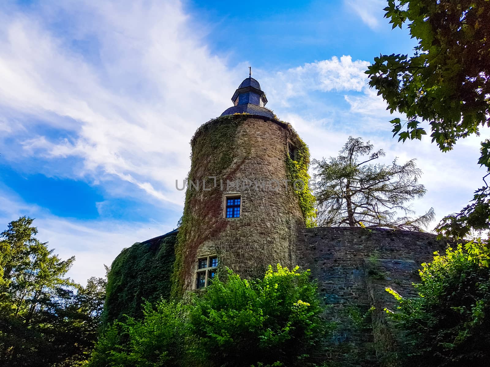 Castle tower of a medieval castle in front of blue sky  by JFsPic