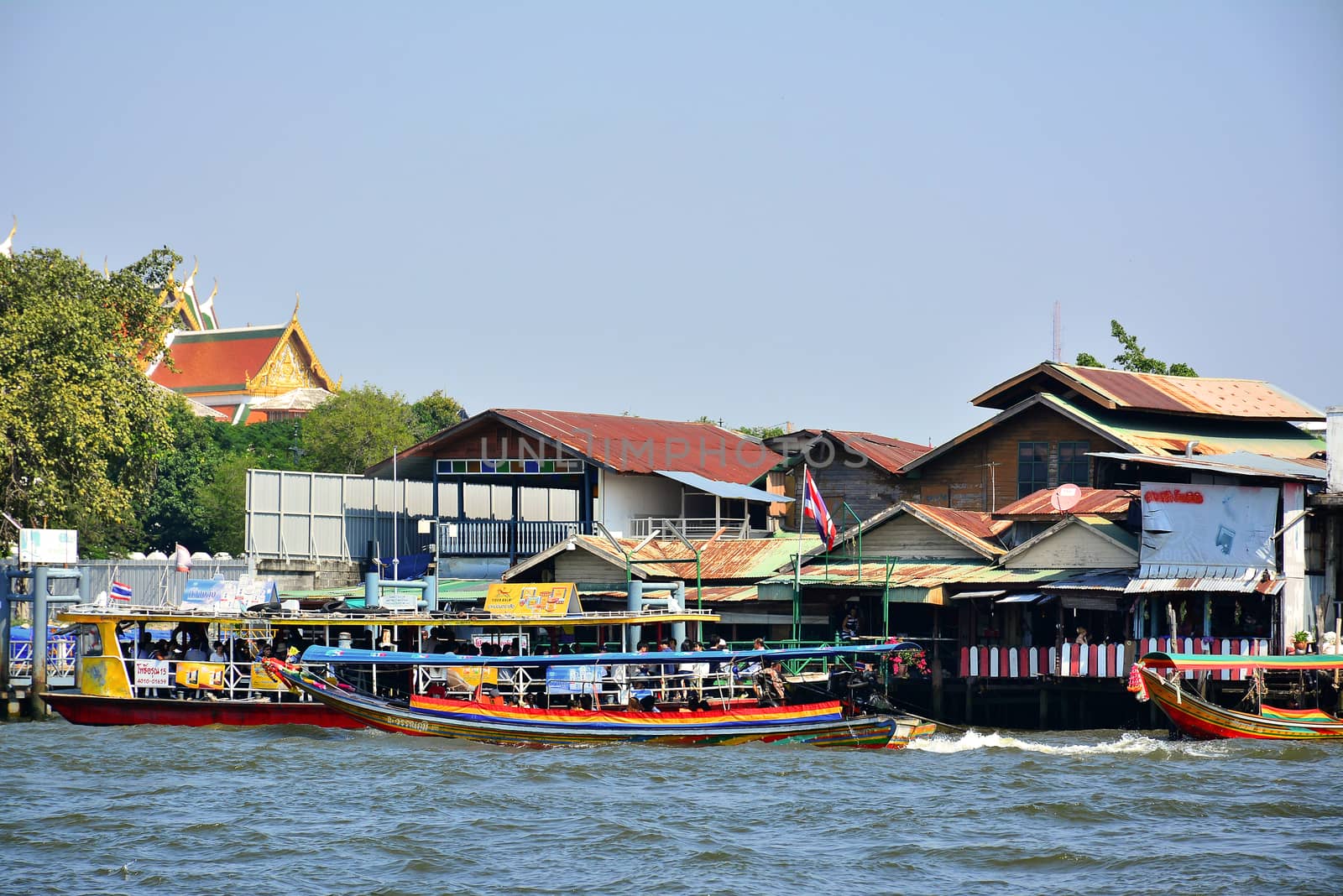 BANGKOK, TH - DEC. 12: Tha Tien ferry boat station terminal on December 12, 2016 in Chao Phraya River, Bangkok, Thailand.