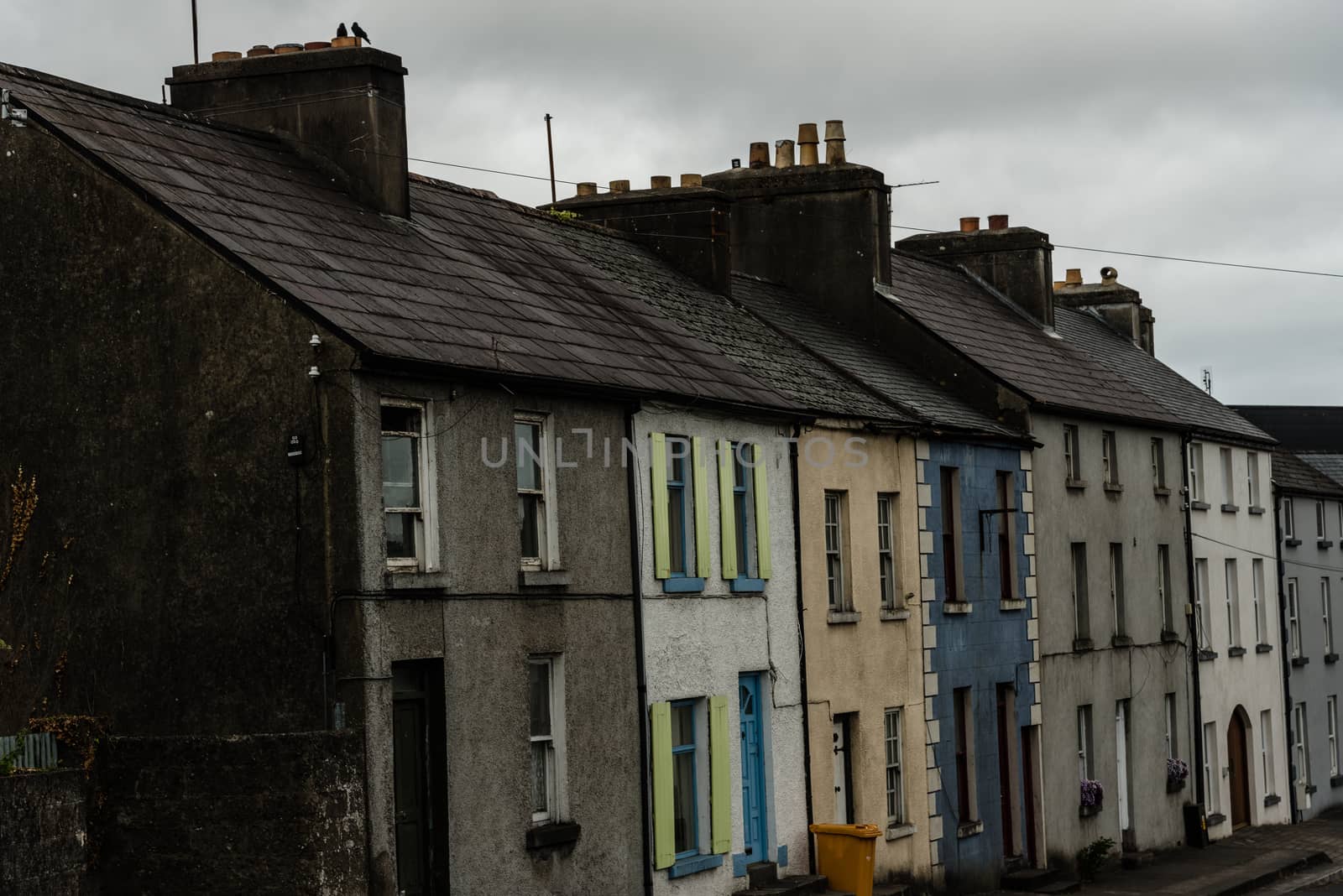 A multi-colored row of houses on a side street in Westport, Ireland.