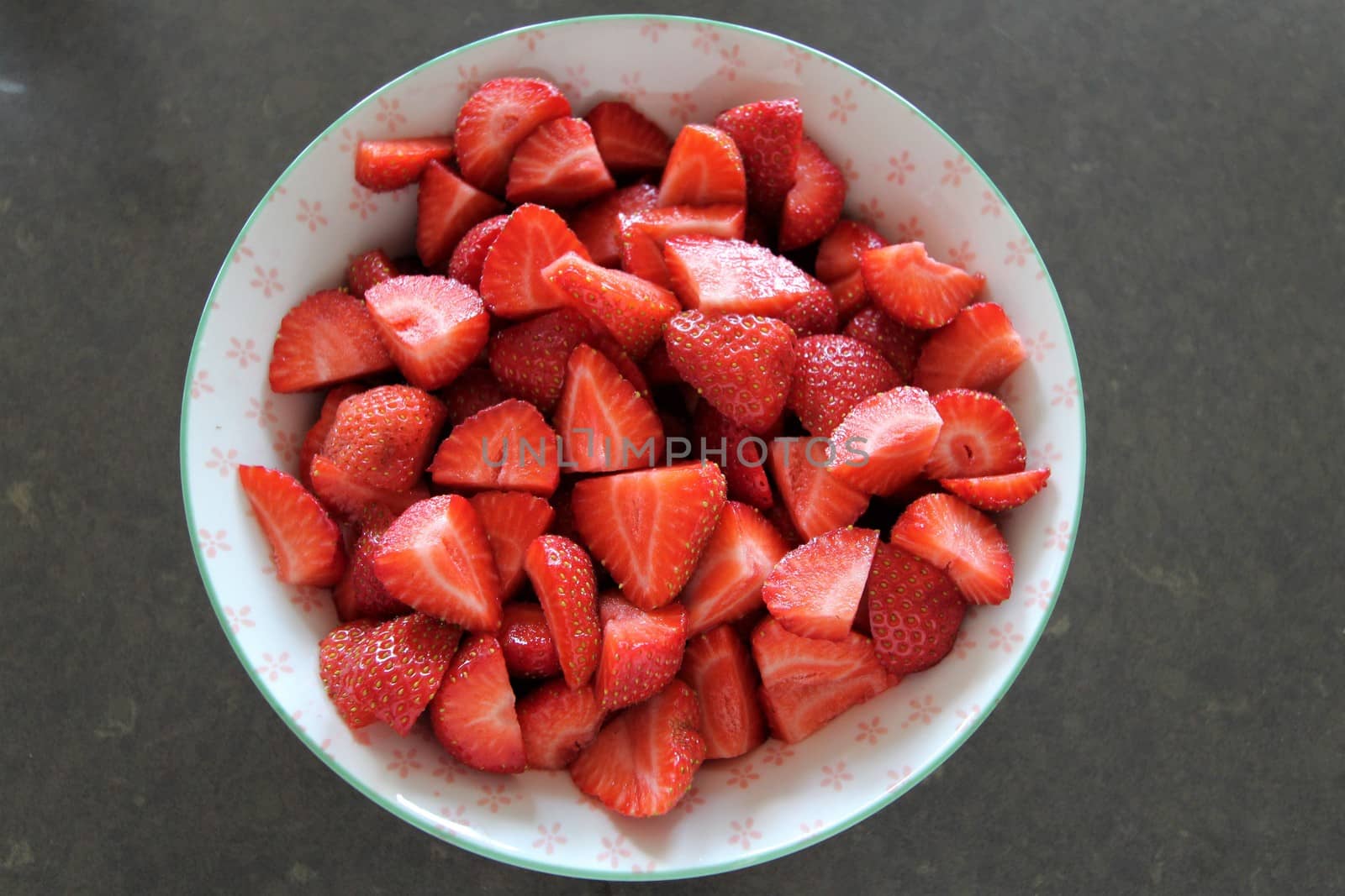 Sliced fresh strawberries in a porcelain bowl by Luise123