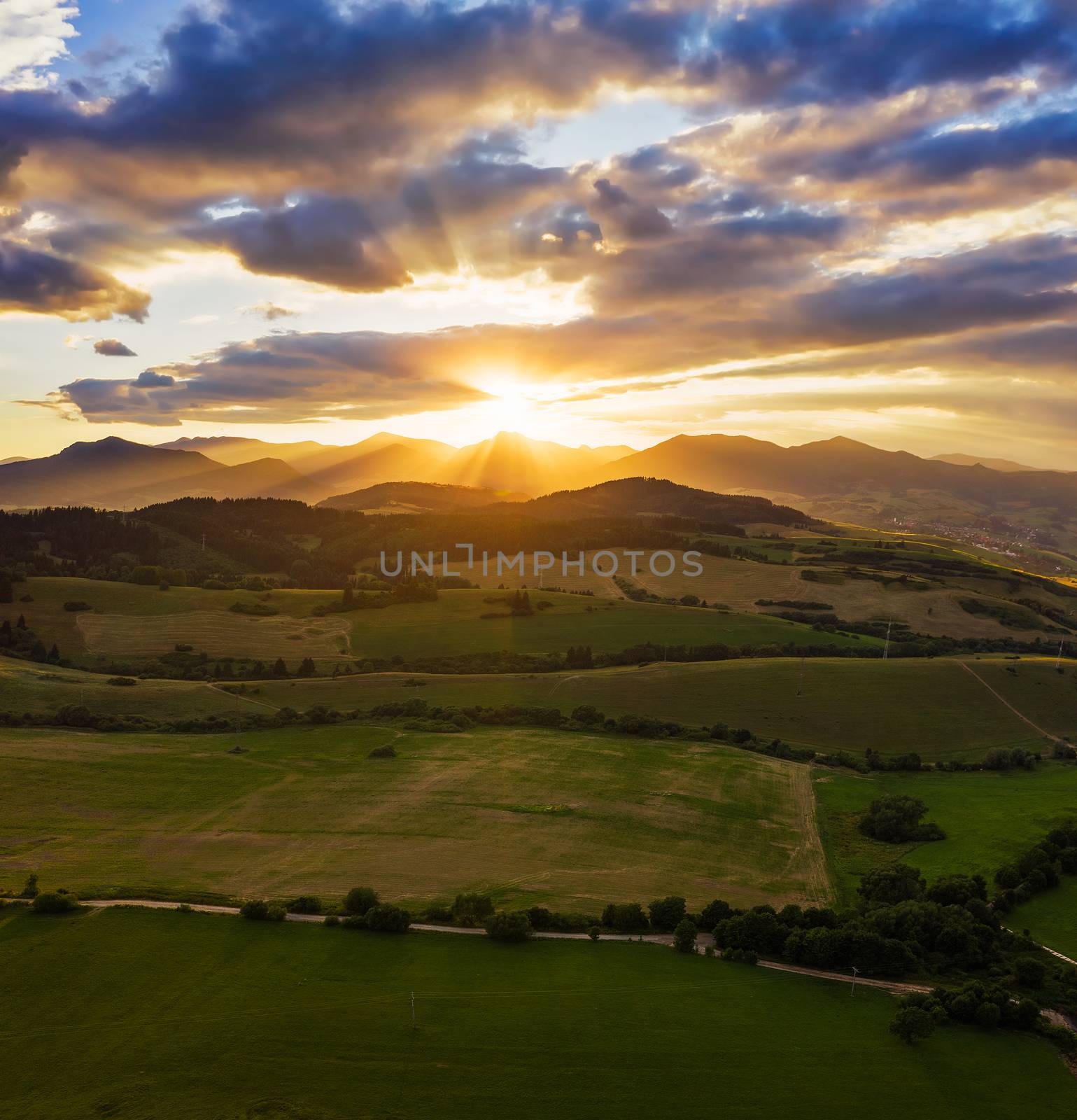 Dramatic sunset above forests and villages of the Liptov region in Slovakia with Great Fatra Mountains in the background