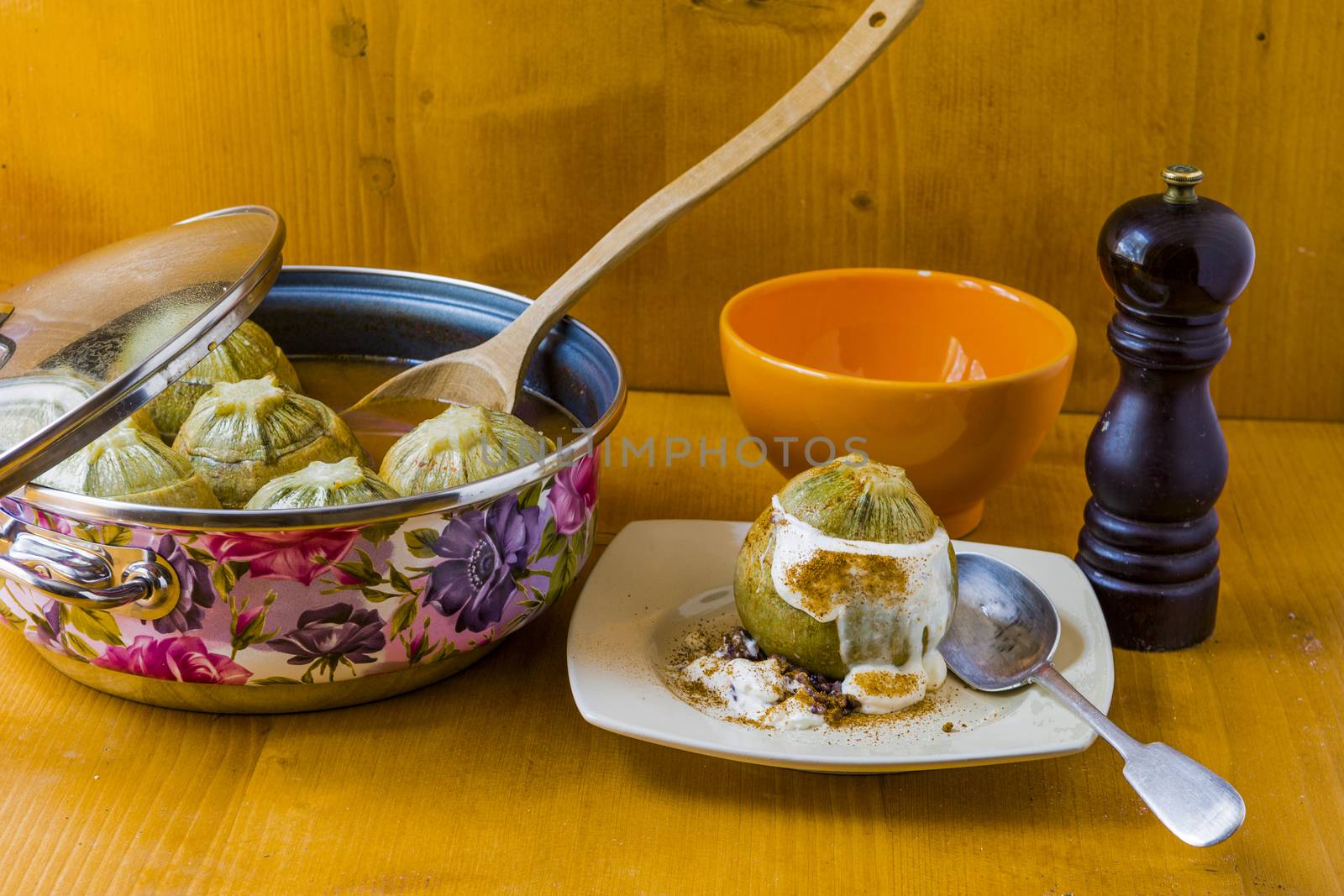 steamed round zucchini filled with meat and rice, seasoned with fragrant black pepper, topped with white sauce.