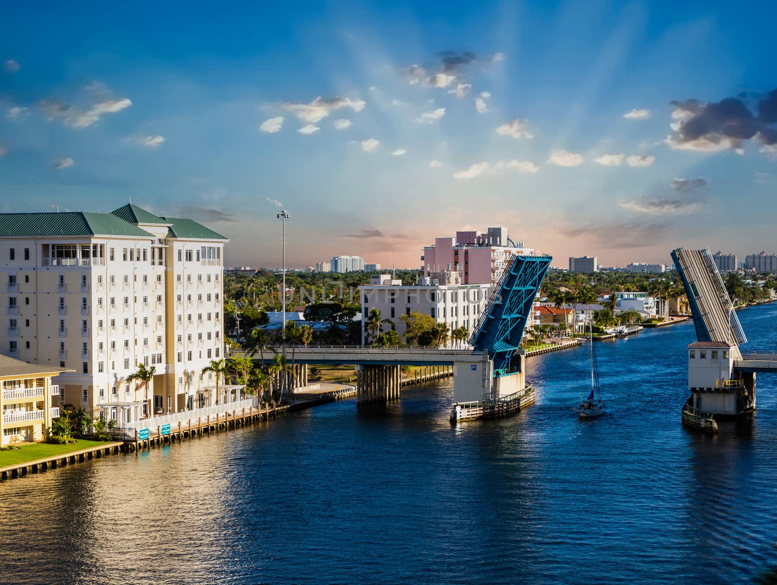 Sailboat Through Drawbridge at Sunrse by dbvirago