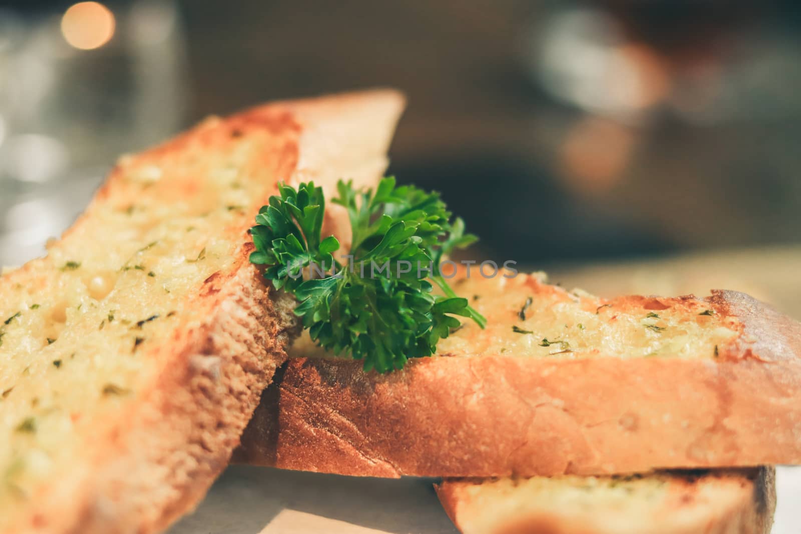 Close up Freshly baked garlic bread on wood plate.