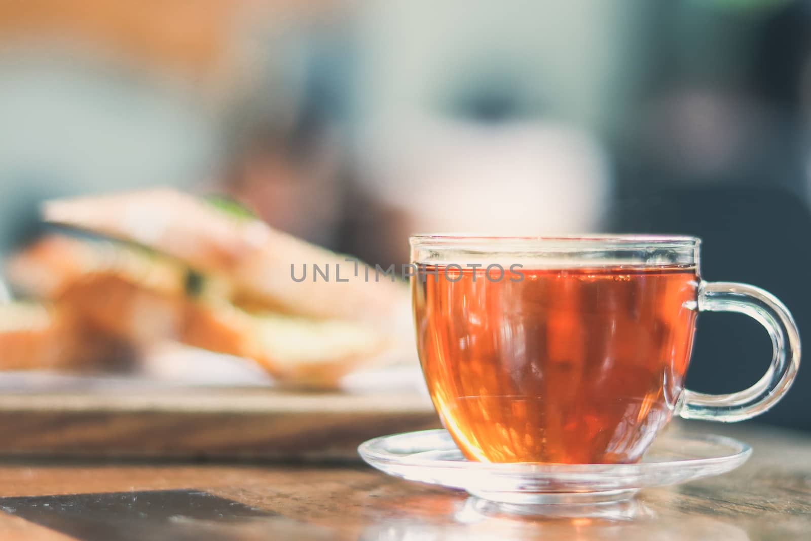 cup of tea at a cafe blurred background and garlic bread. by anotestocker