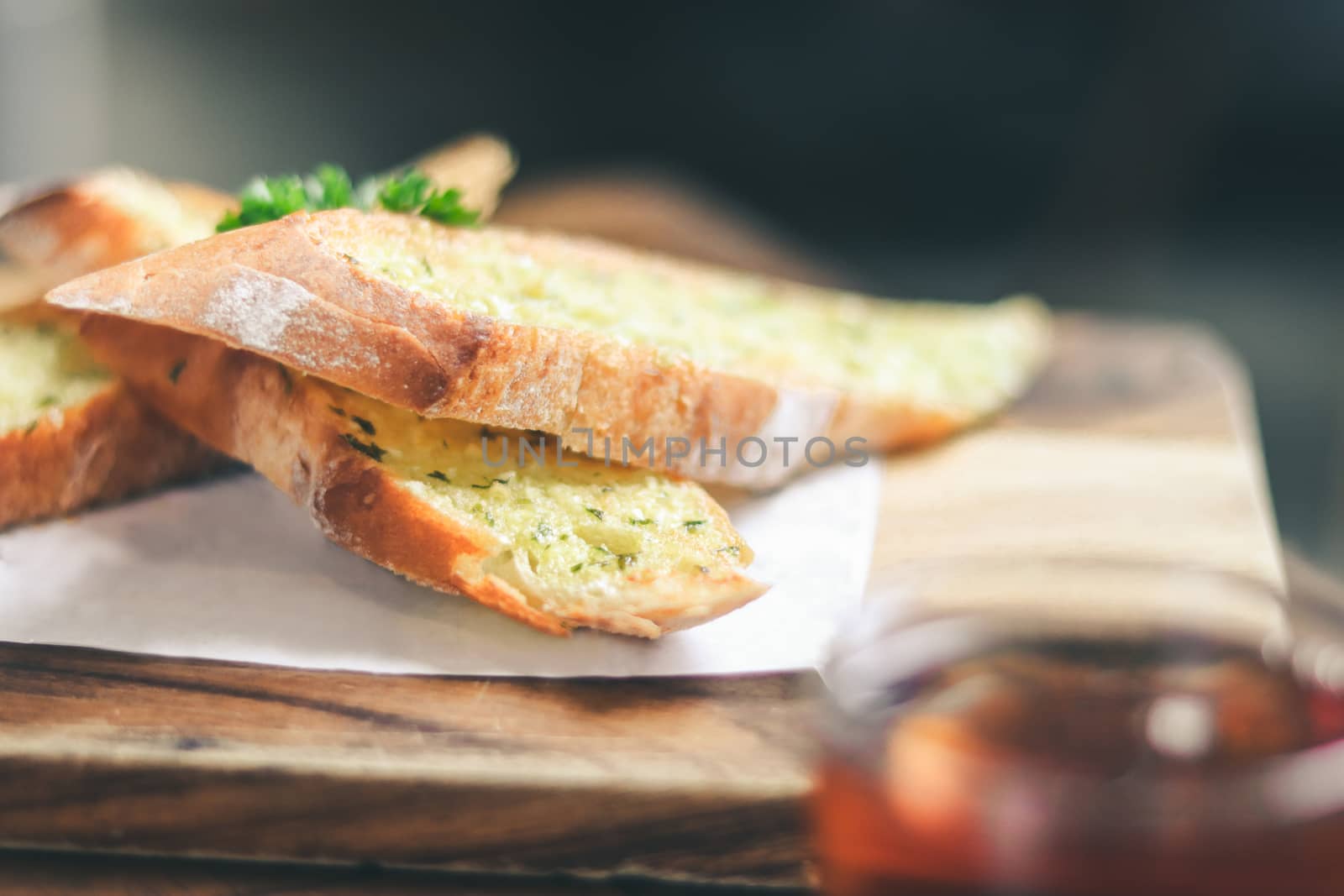 Close up Freshly baked garlic bread with teacup Foreground.