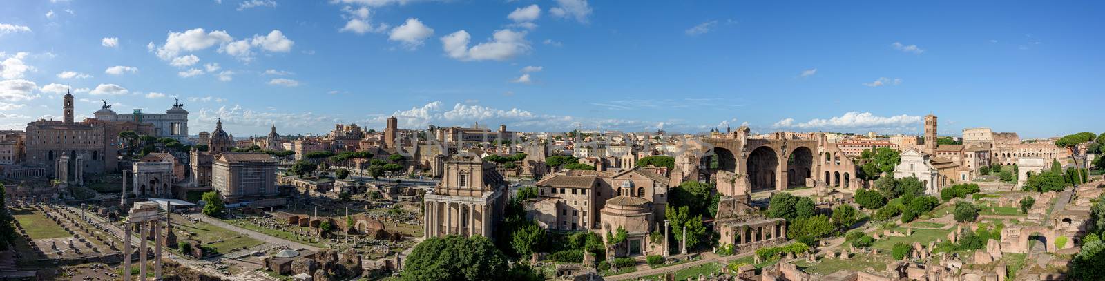 Panorama of the ancient Roman Forums, an archeological park with ancient temples of the Roman Empire, basilica churches and public buildings, near the Colosseum theater and the Capitoline Hill, in the city centre of Rome, Italy