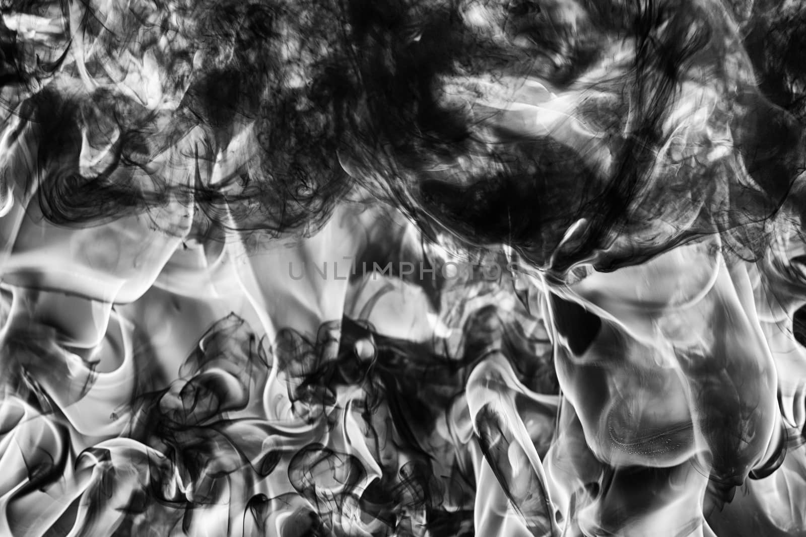 Dramatic Abstract plume of natural black smoke and white huge flame of strong fire, high temperature flames. Motion blur. Dramatic moody black and white image. Dangerous firestorm abstract background