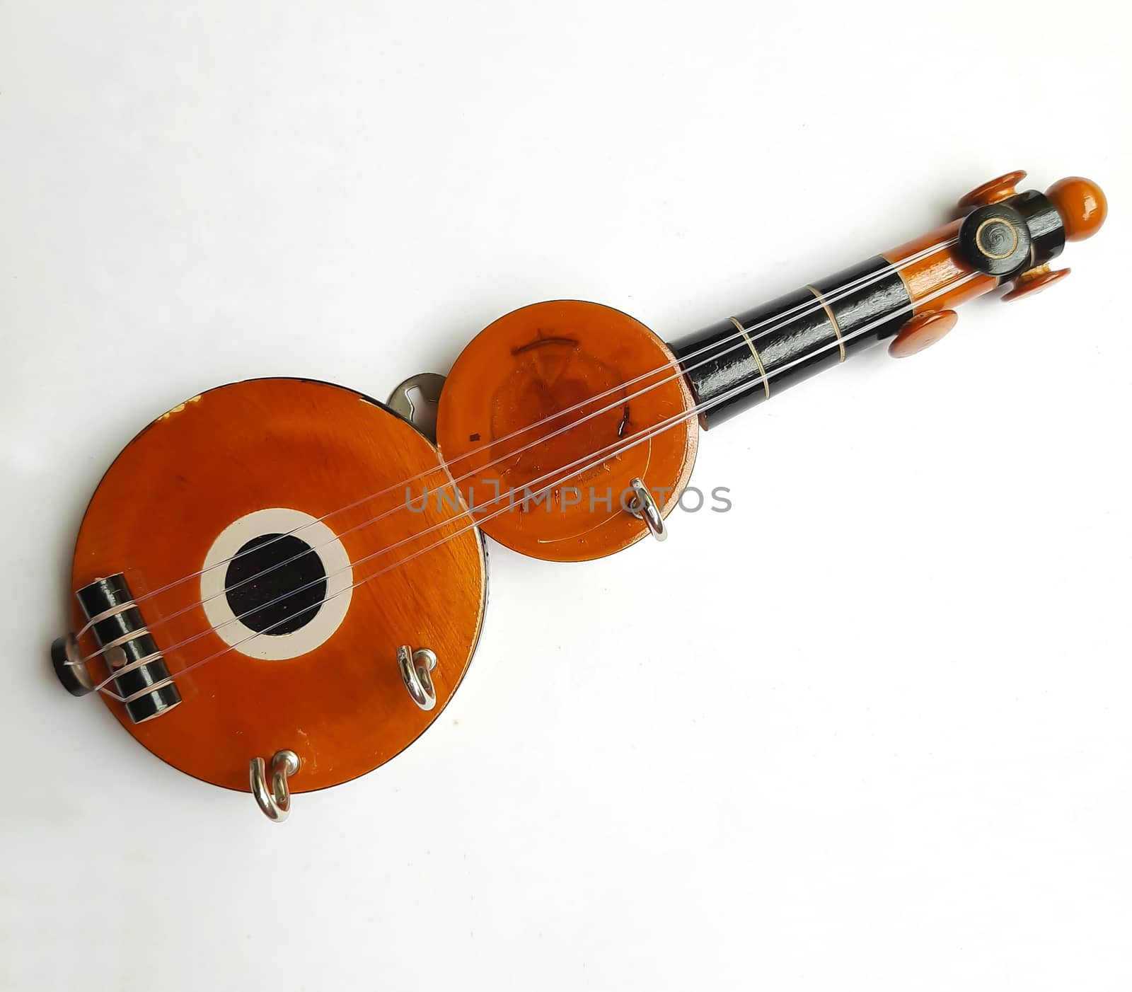 Chennai, India - July 14 2020: Guitar shape Key chain hanger placed beautifully in white background for interior home decorations