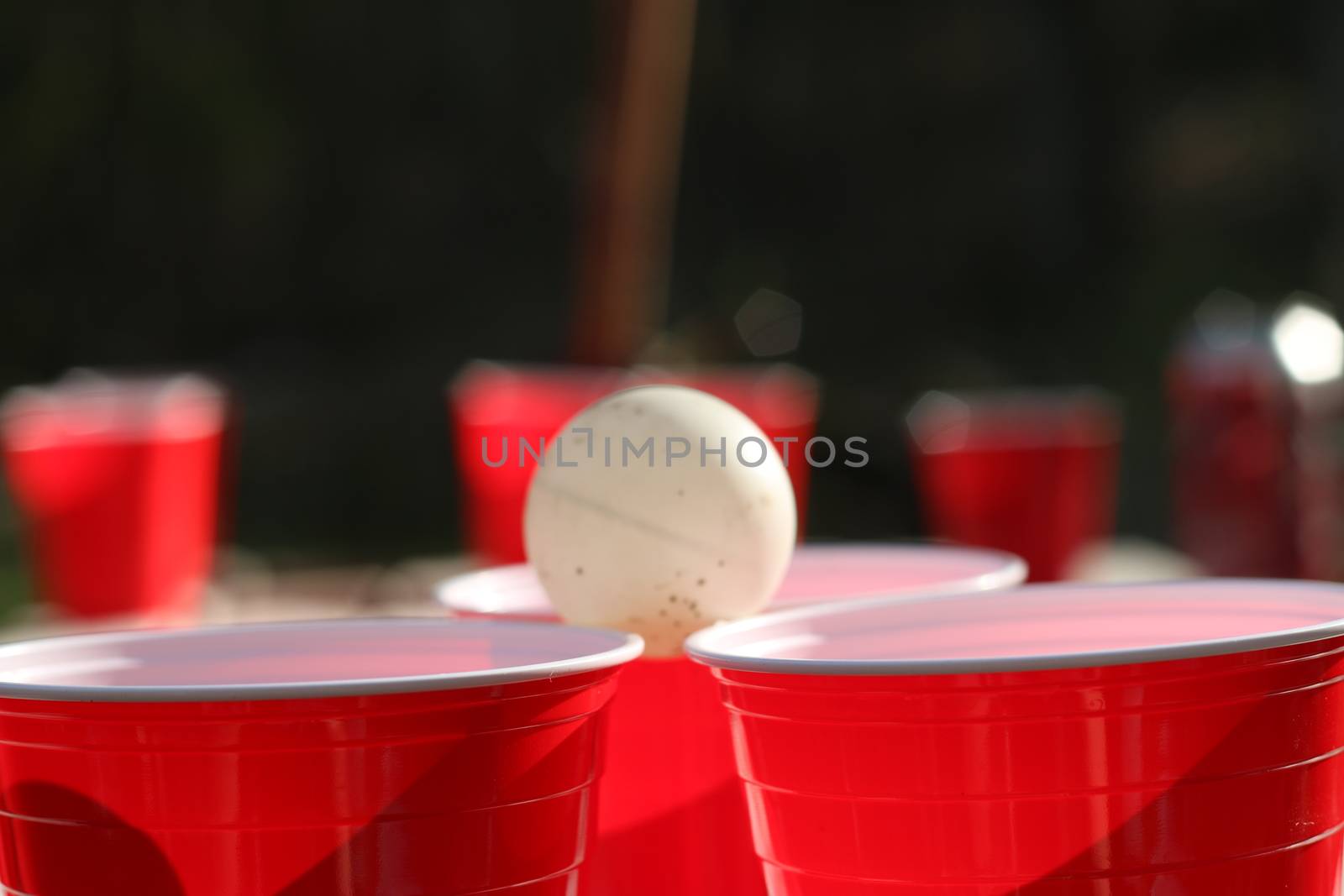 Red party cups themed background template. White backdrop. Alcohol container on its side. People dancing hands up in the air. Empty blank copy space. Event marketing and promotion