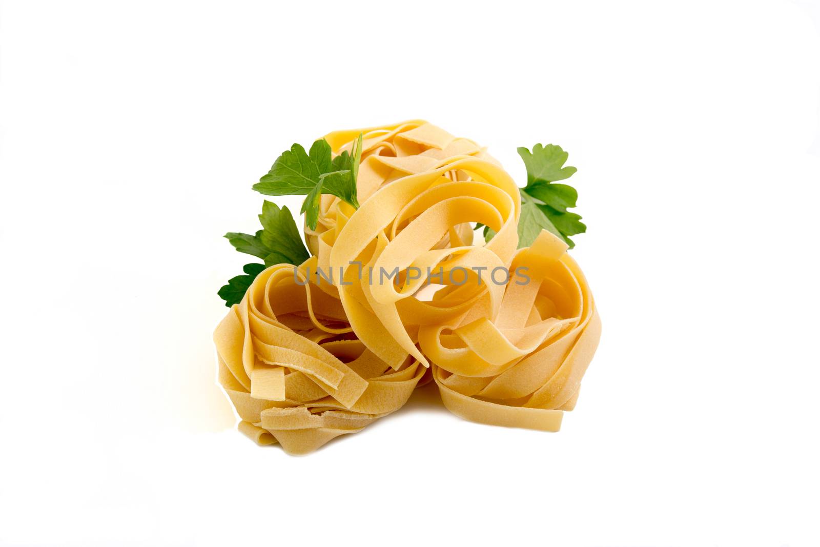 Tagliatelle raw pasta nest egg to dry,
on isolated background