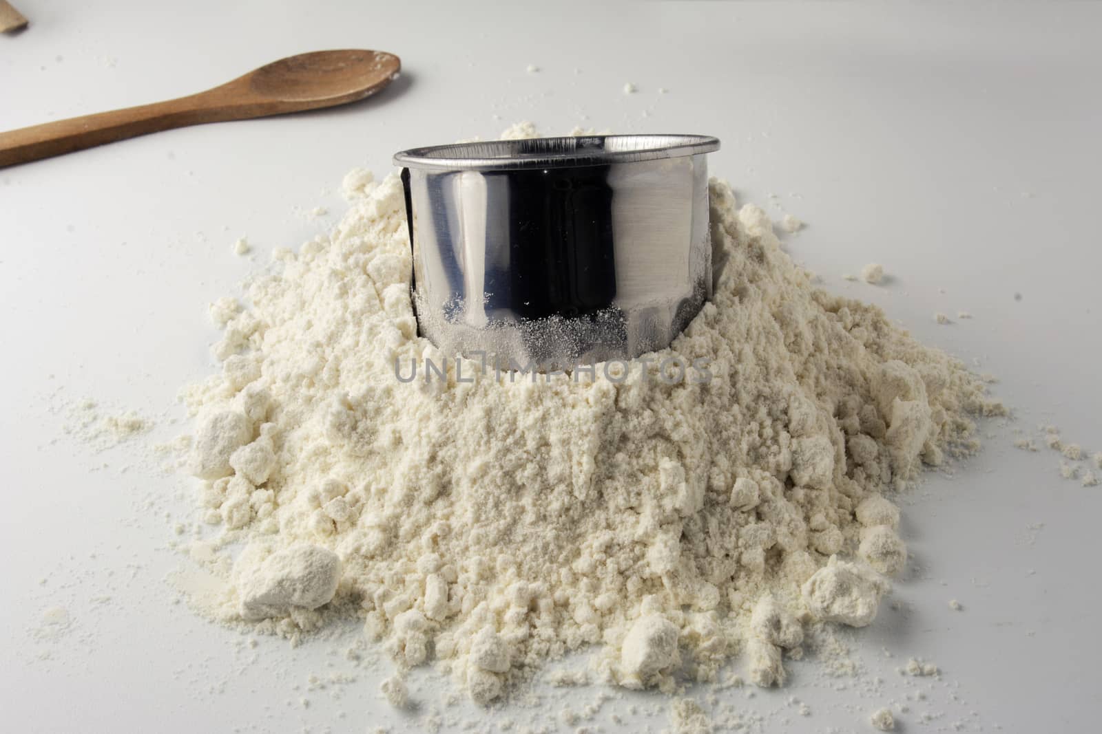 pastry cutters and flour on white wooden board 