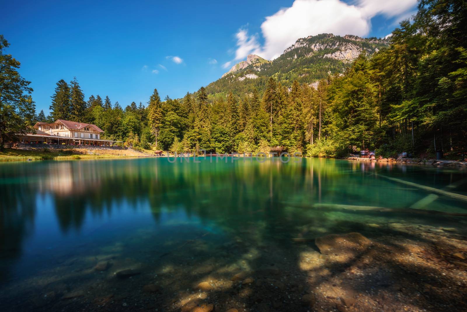 Mountain lake Blausee located in the Kander valley above Kandergrund in the Jungfrau region. Long exposure.