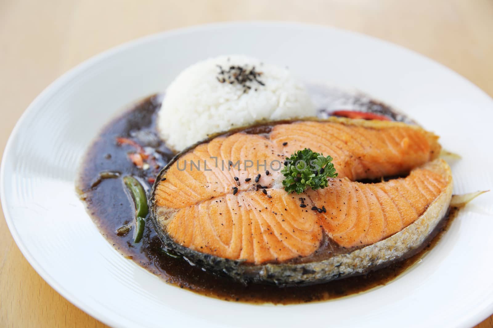 salmon black paper with rice on wood background