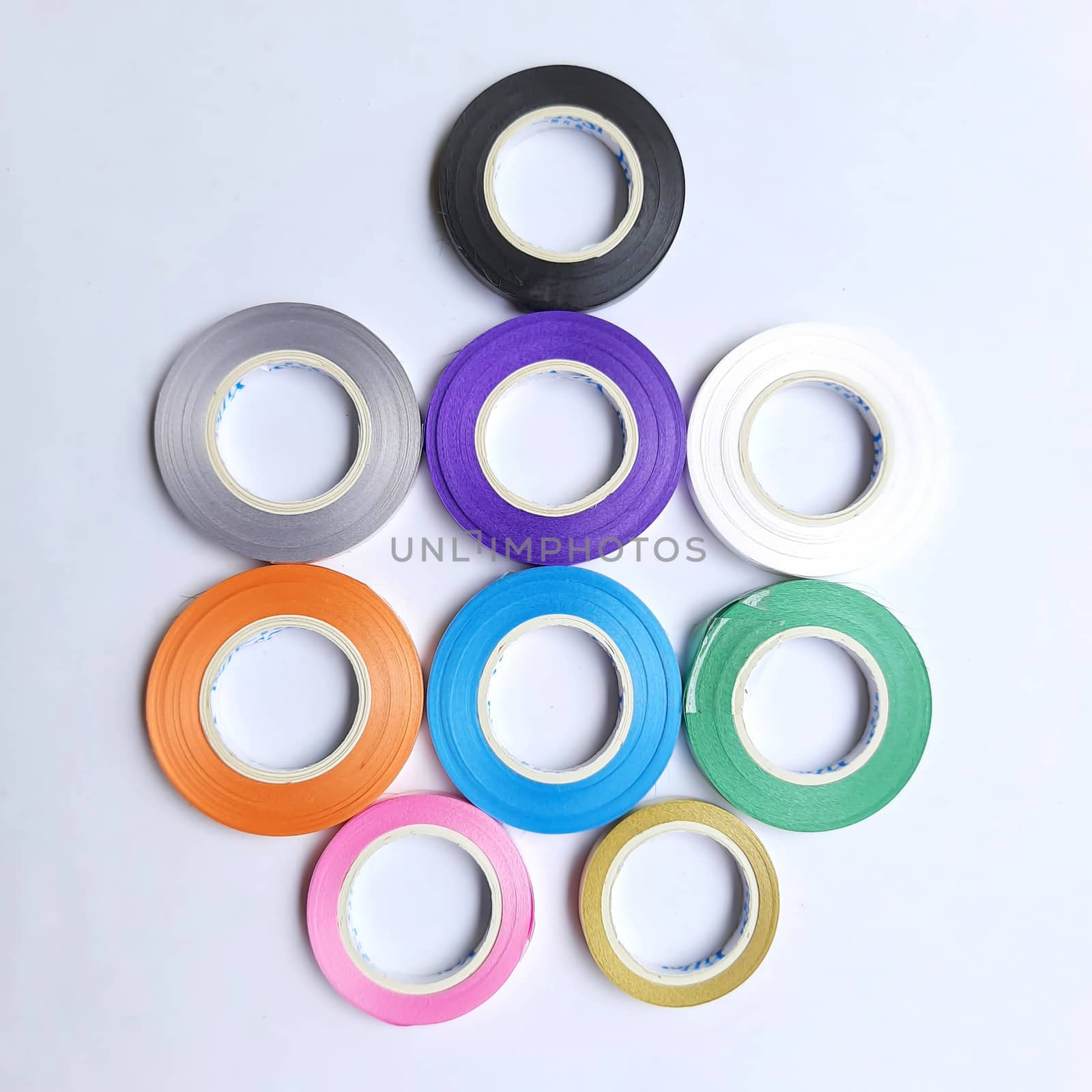 Multi colored curling ribbon arranged beautifully in white chart as backgrounds