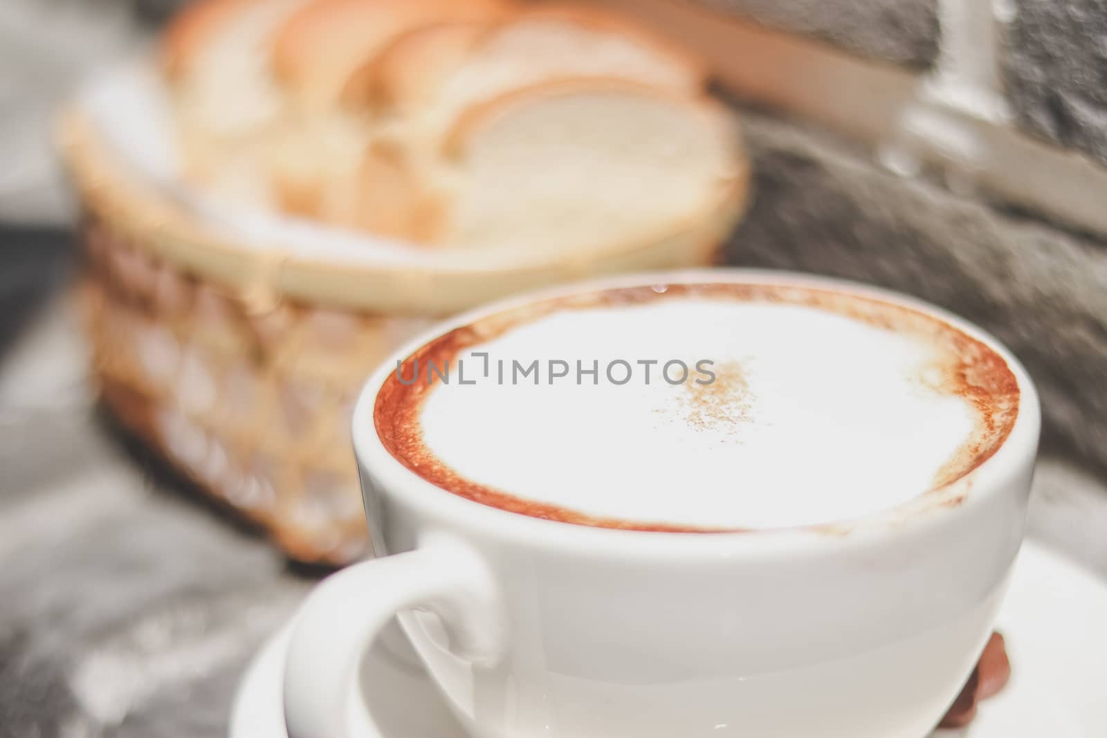 cappuccino coffee and Toast in the basket with morning light. breakfast.