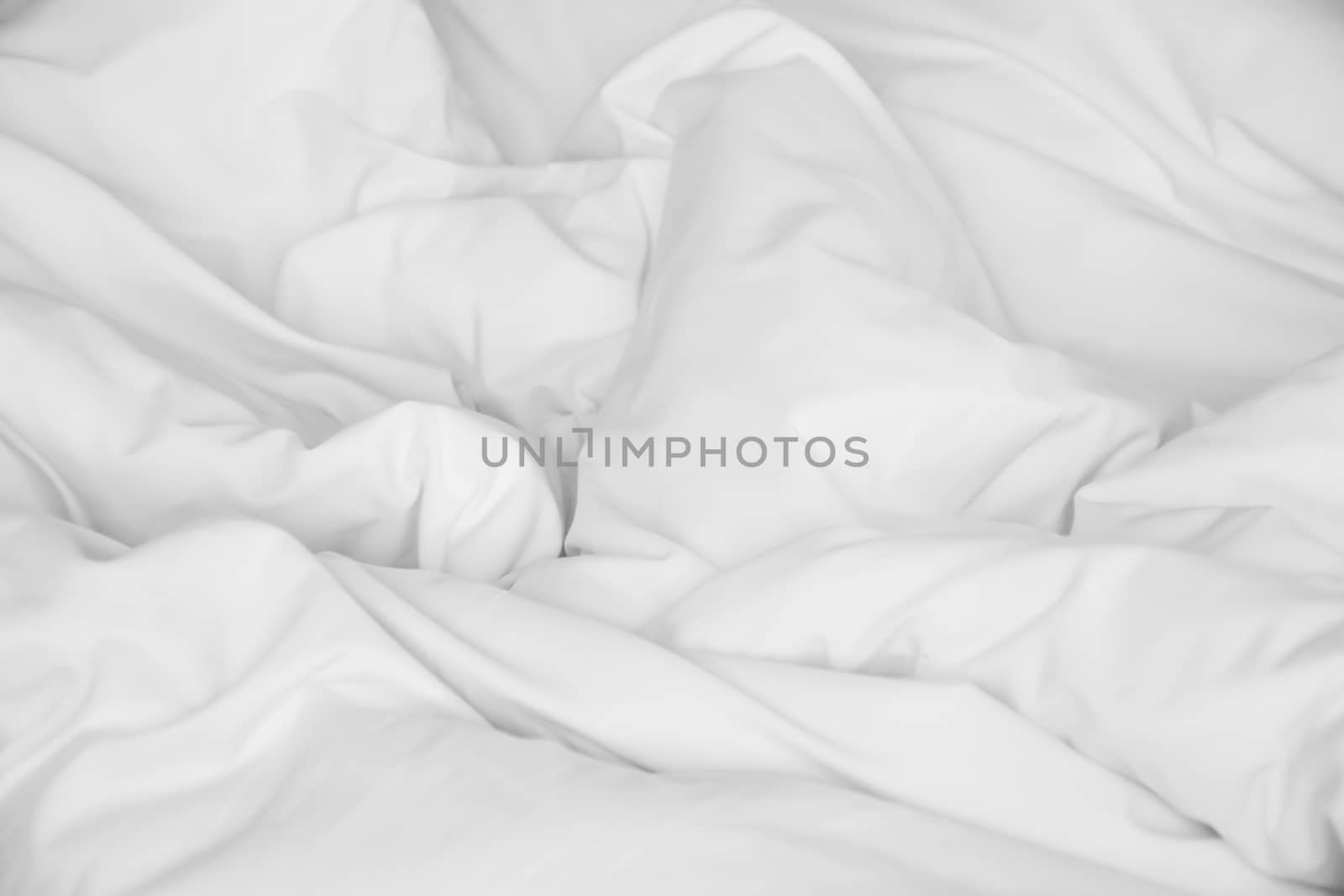 Crumpled white fabric cloth texture background.