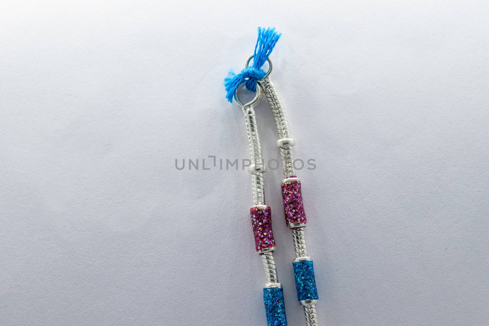 silver leg chain design with red and blue stones on the white background (anklet)