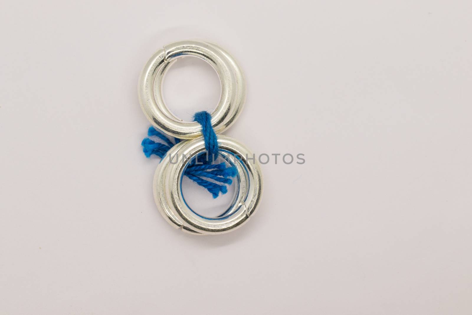 two pair leg silver rings with blue threats on white background