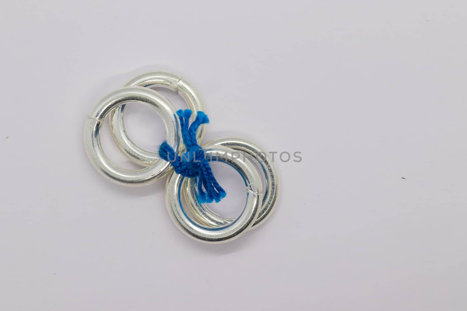 four silver leg round rings on white background