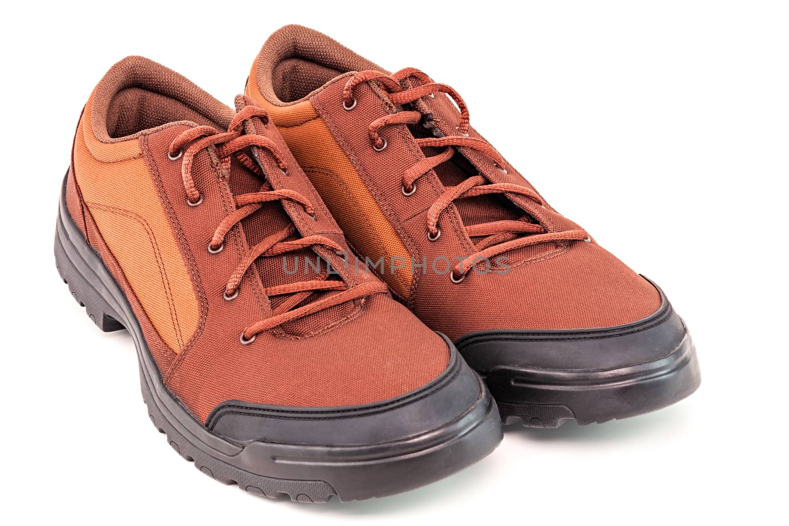a pair of orange cheap durable fabric travel shoes isolated on white background.