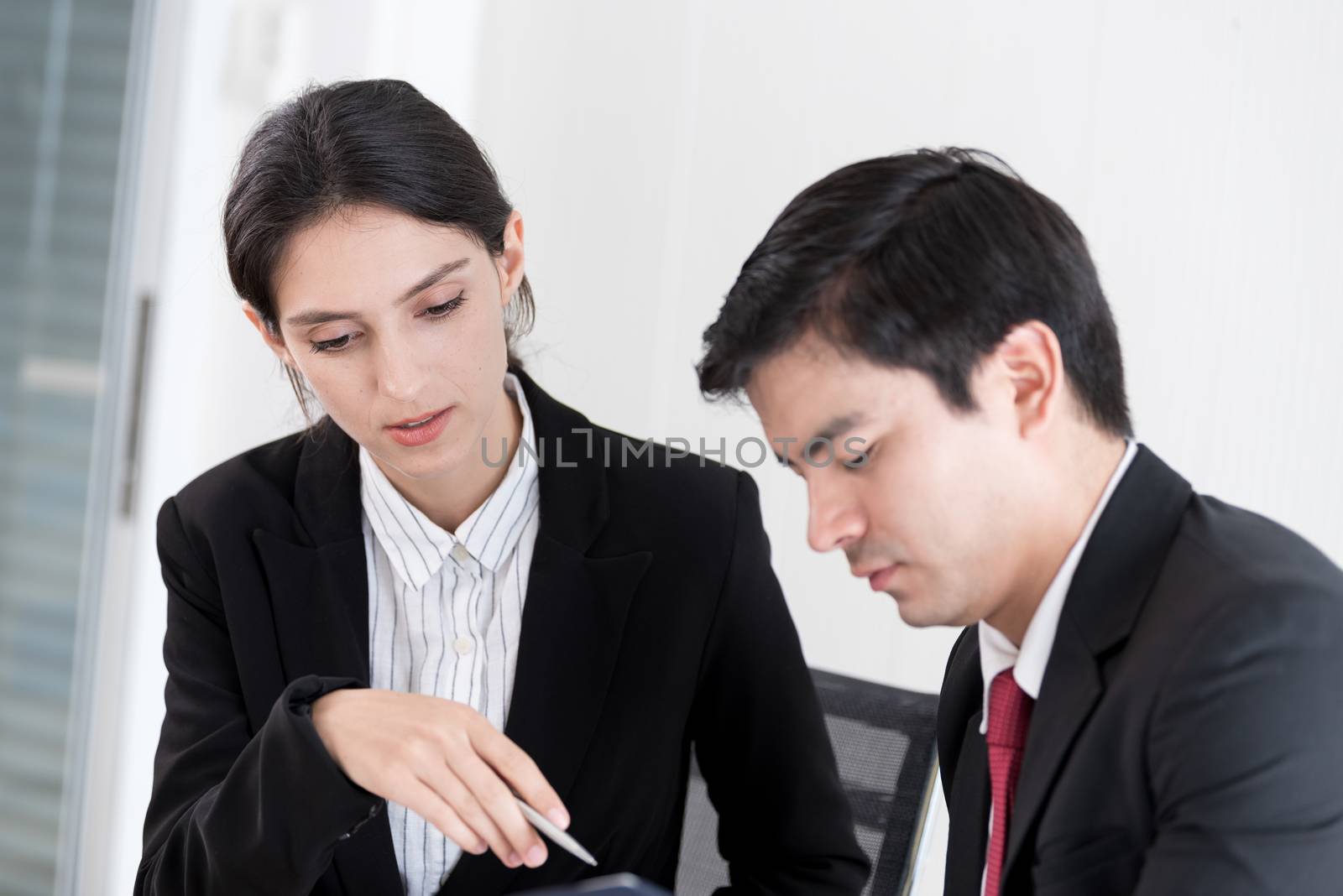 A manager and secretary working together in the office.