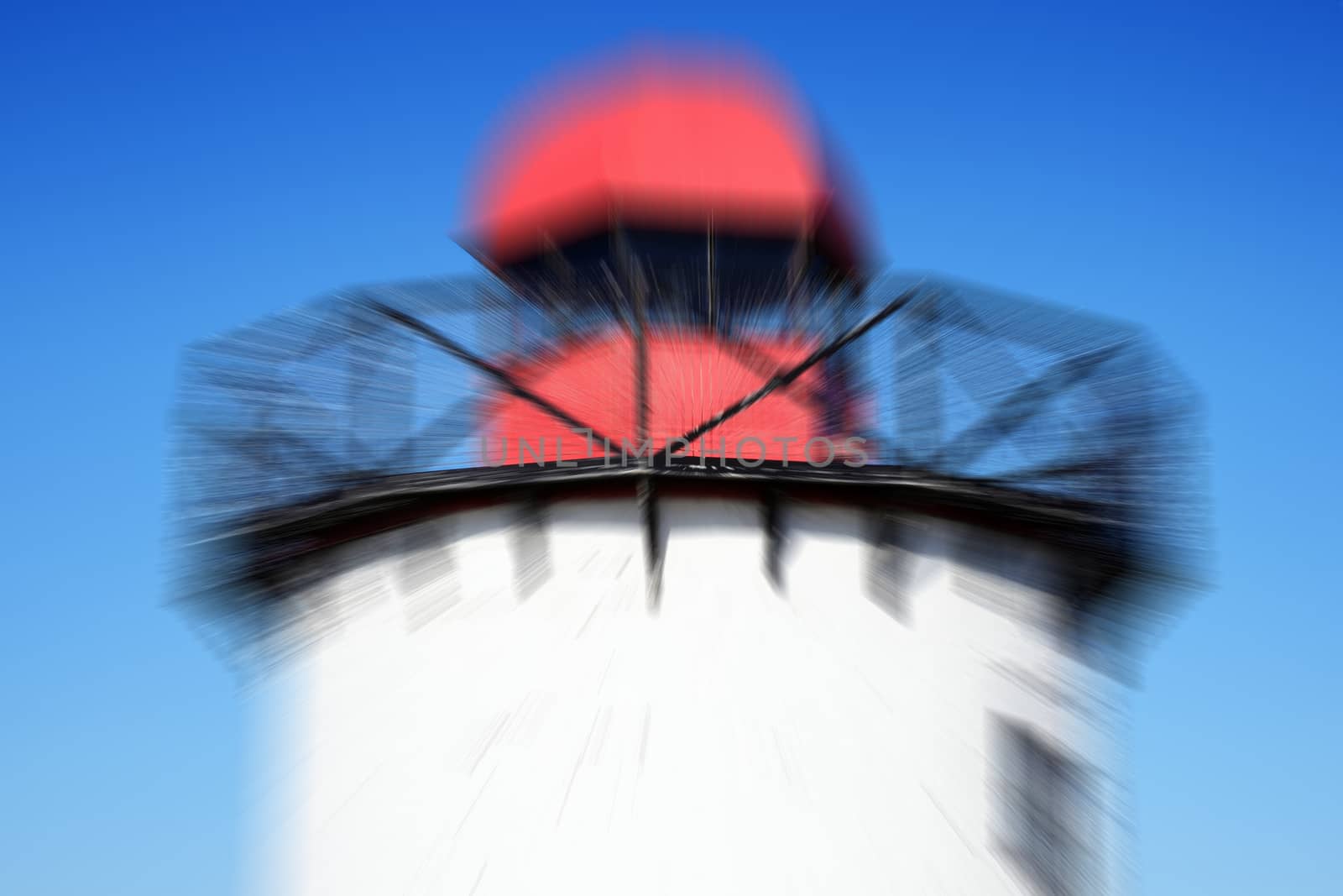 Old 19th century Georgian lighthouse at Burry Port, Carmarthenshire Wales UK with a zoom burst blur effect stock photo