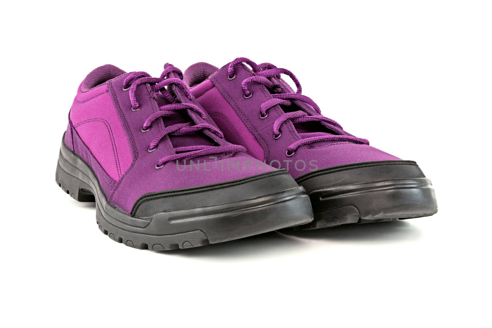 a pair of simple cheap purple hiking shoes isolated on white background - perspective close-up view by z1b