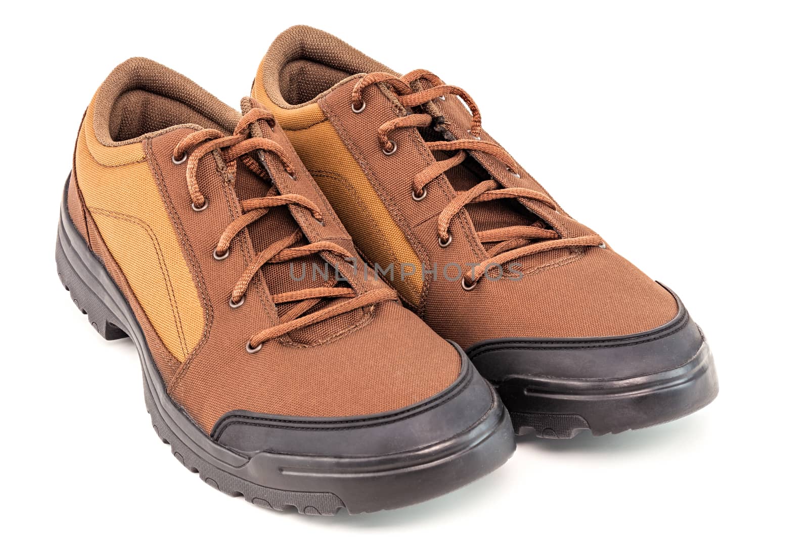 a pair of brown cheap durable fabric travel shoes isolated on white background.