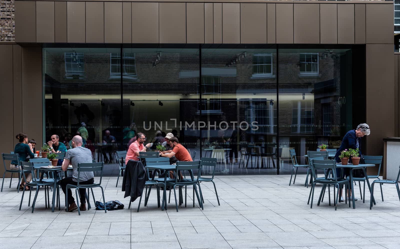 Dublin, Ireland--July 16, 2018. Patrons of the Irish Emigration Museum enjoy coffee and snacks in the museum courtyard.