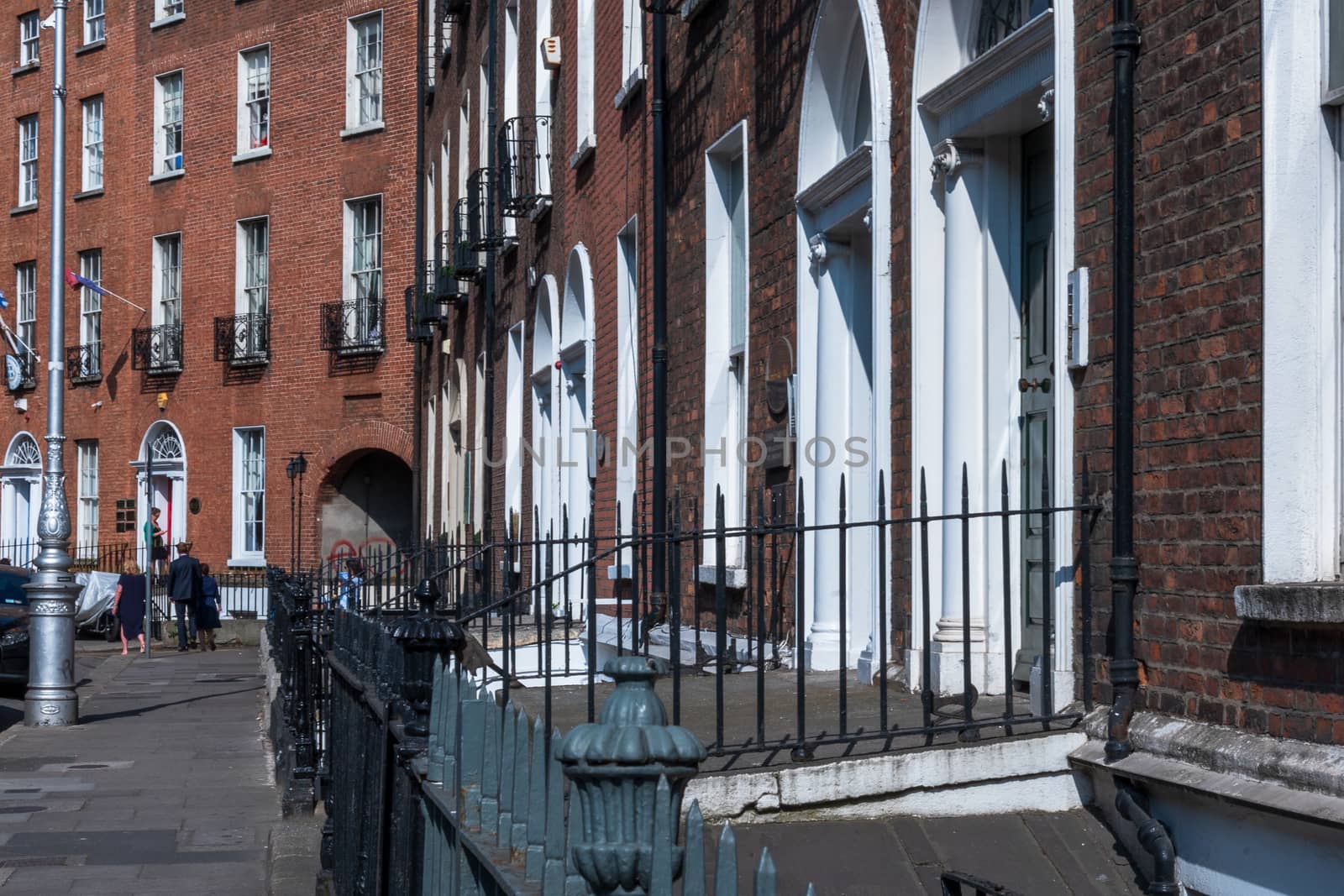 Dublin, Ireland -- July 9, 2018.  A row of red brick flats with white doorways in an attractive  Dublin neighborhood.