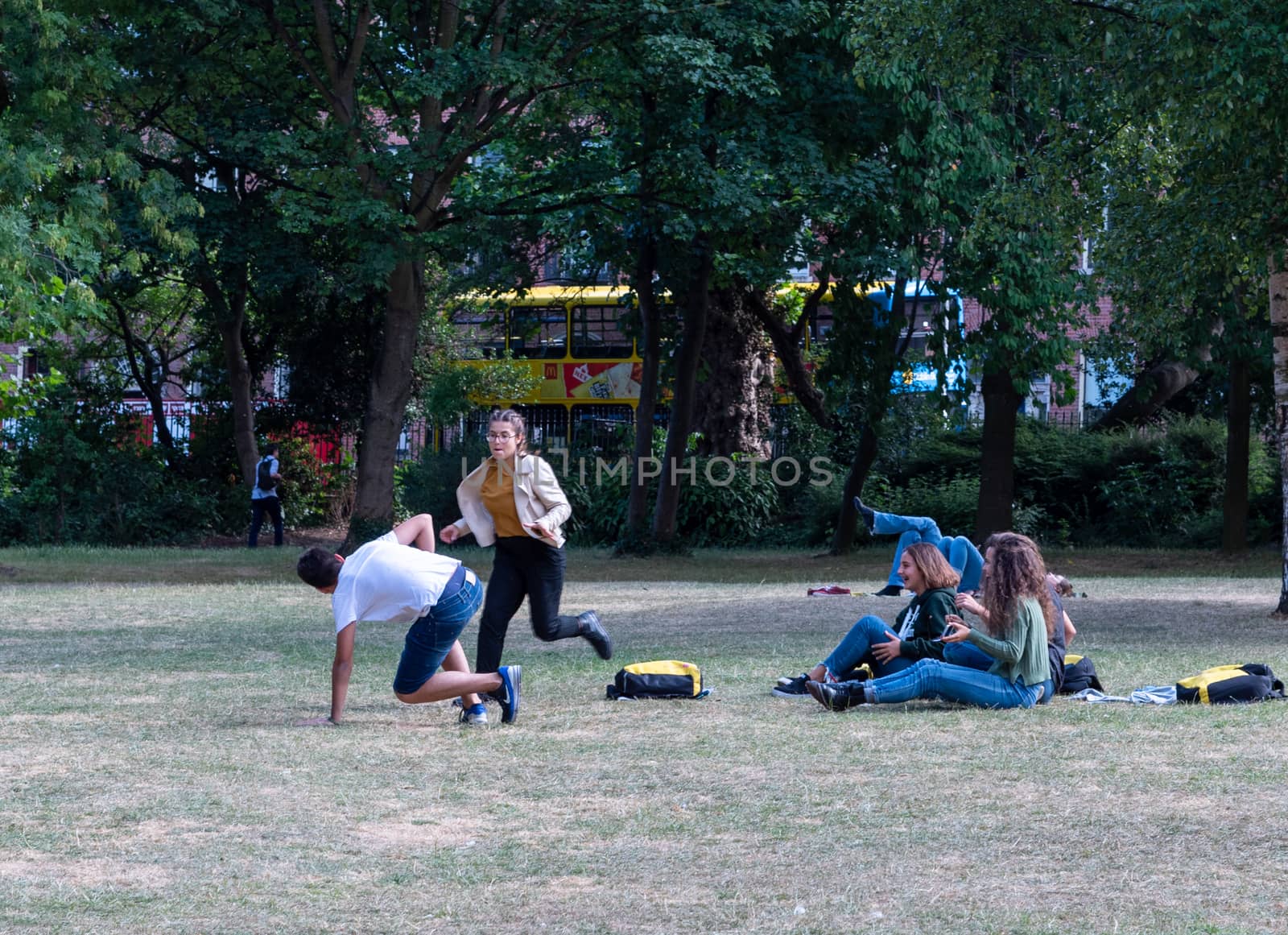 Dublin, Ireland -- July 9, 2018.  Students frolic in a Dublin park on a hot summer day.