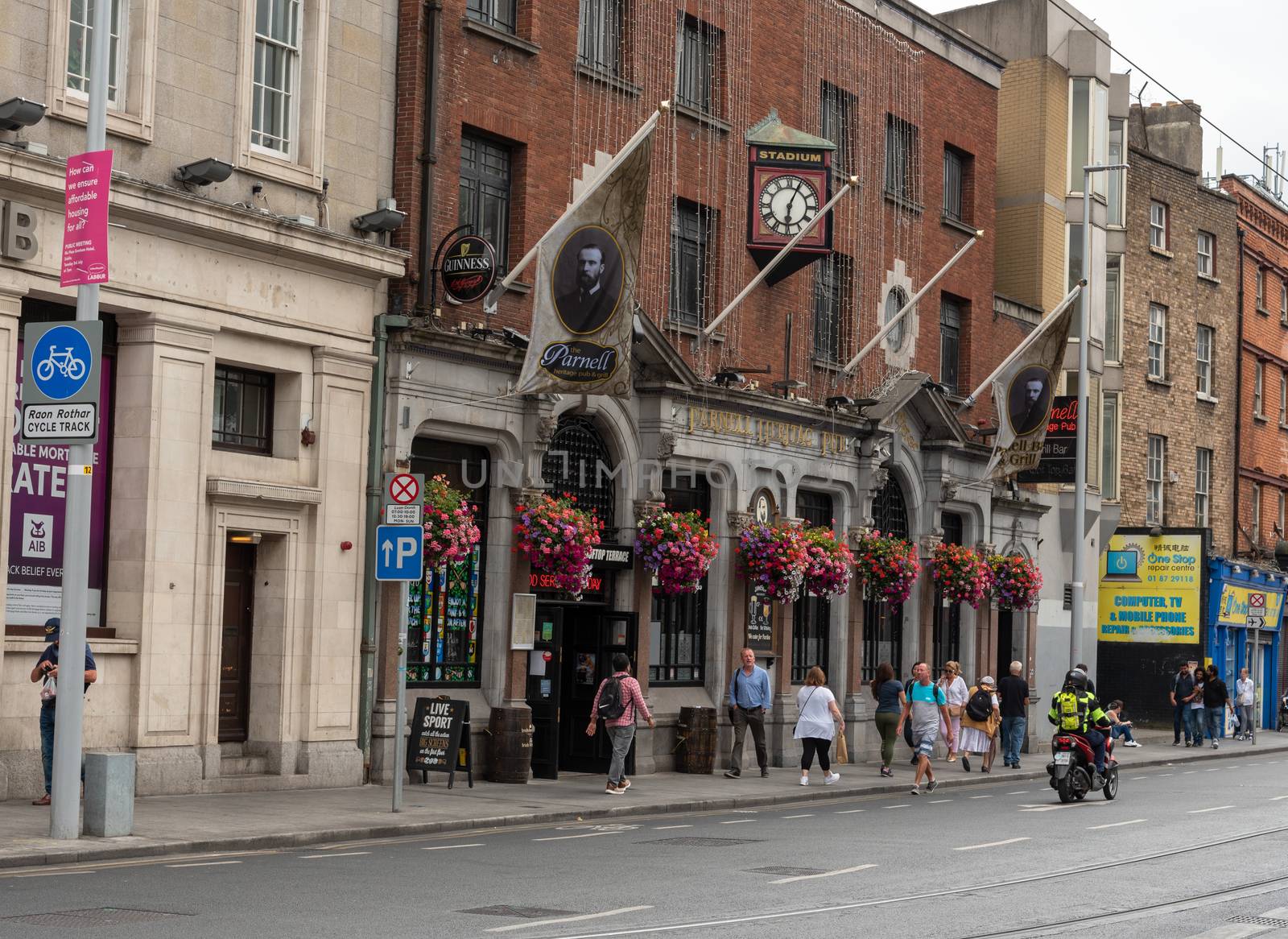 Dublin, Ireland -- July 9, 2018.  Pedestrians are walking past the front of a pub in Dublin, Ireland.