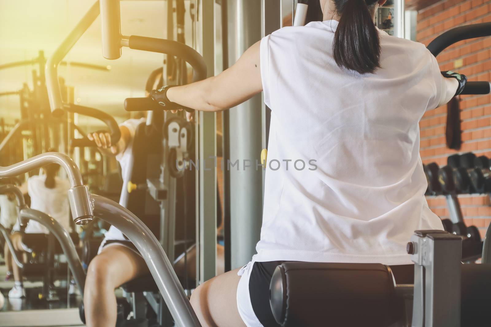 woman exercise workout on machine in gym.Concept of fitness. by anotestocker