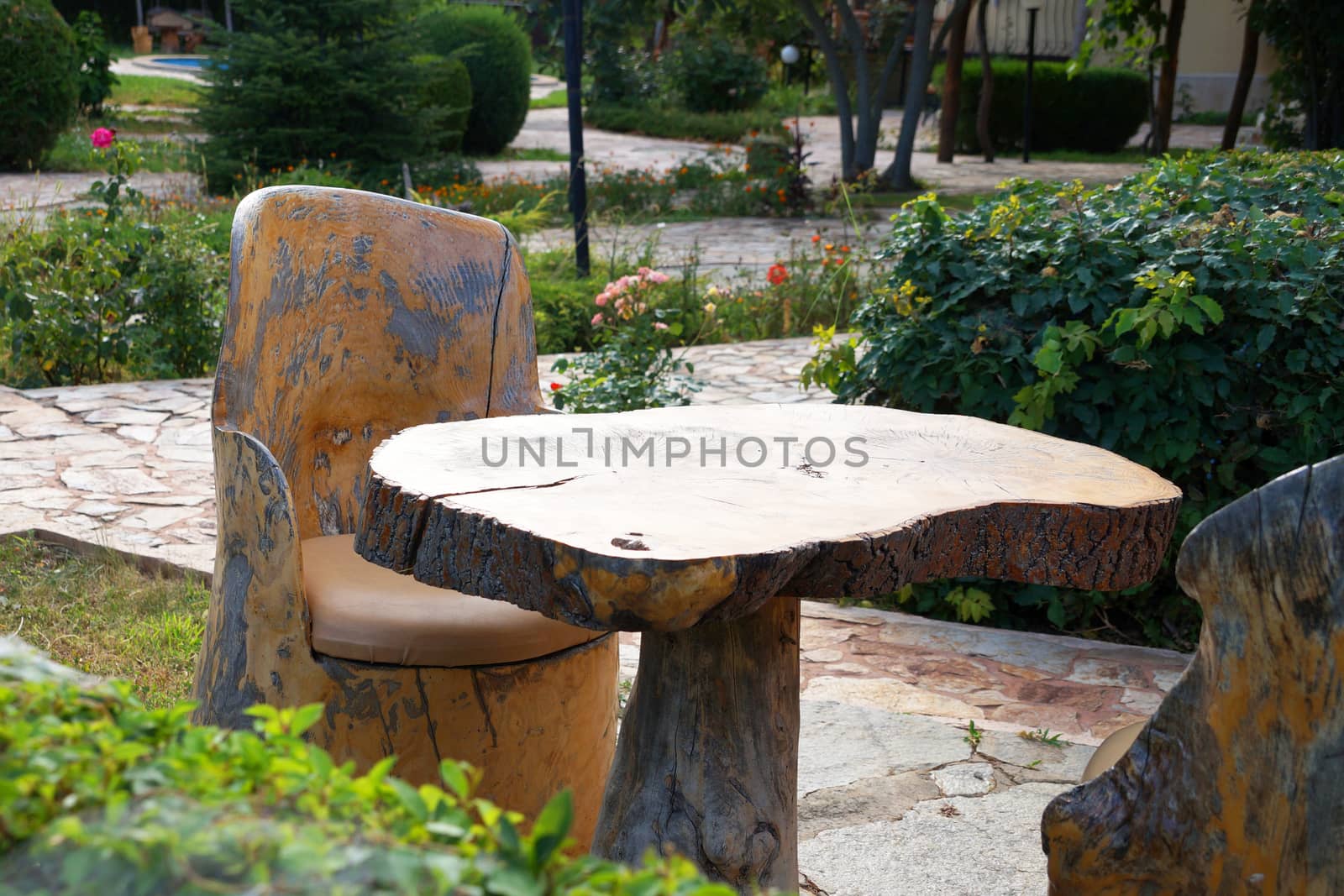 raw wood table and chairs in the park by Annado