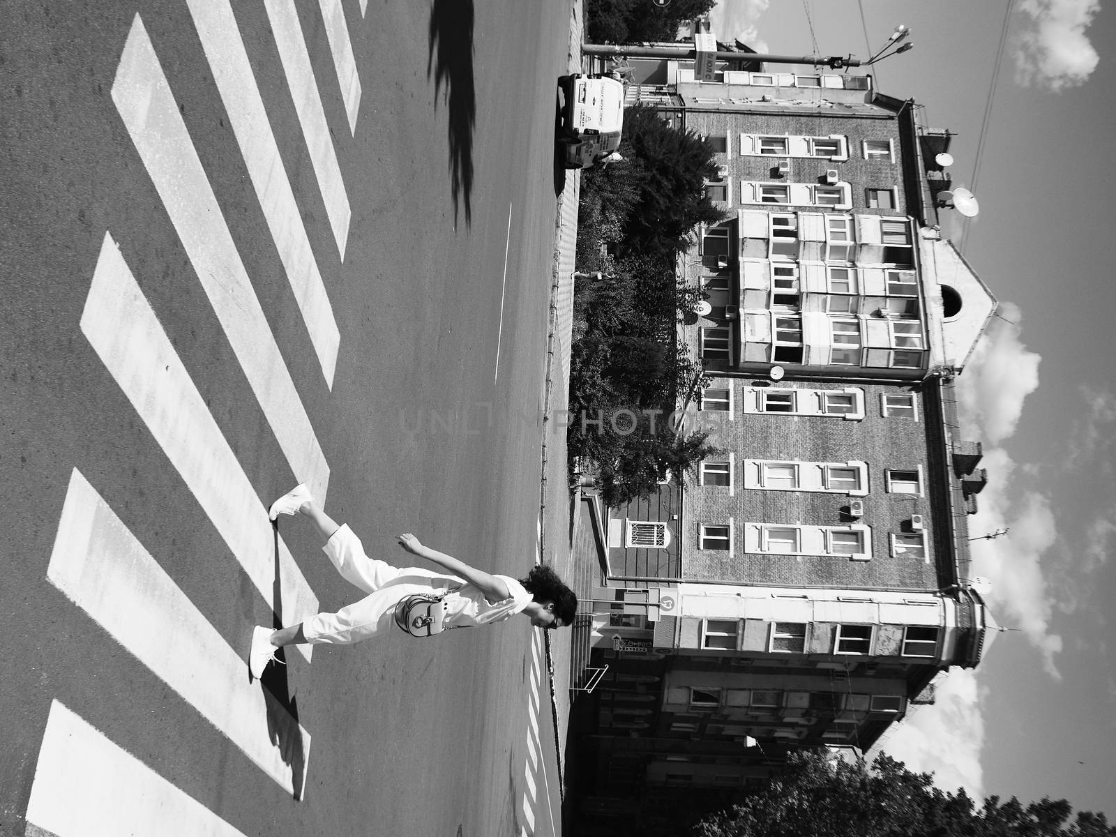 Poltava, Ukraine - July 18, 2020: casual look on the people walking on the city street at sunny noon by VIIIPhoto