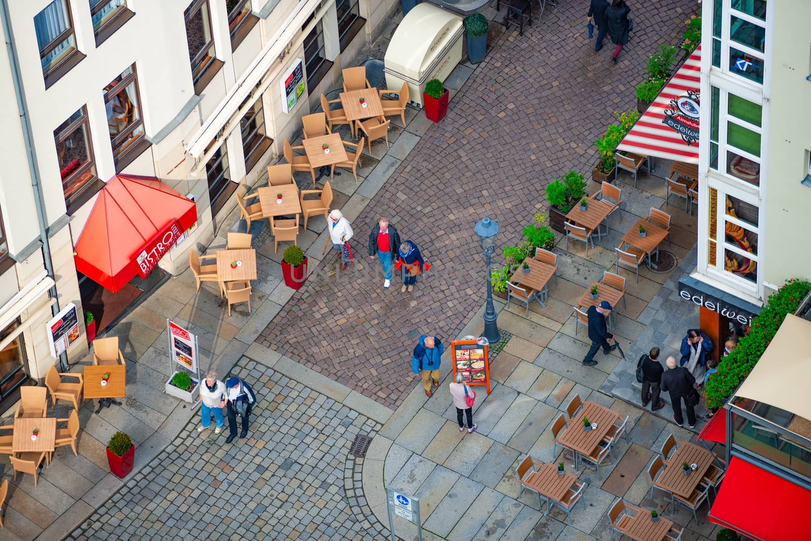 DRESDEN, GERMANY - SEPTEMBER 22, 2014: Top down view on street of Dresden, state of Saxony, Germany, Europe. Restaurant and people down below.