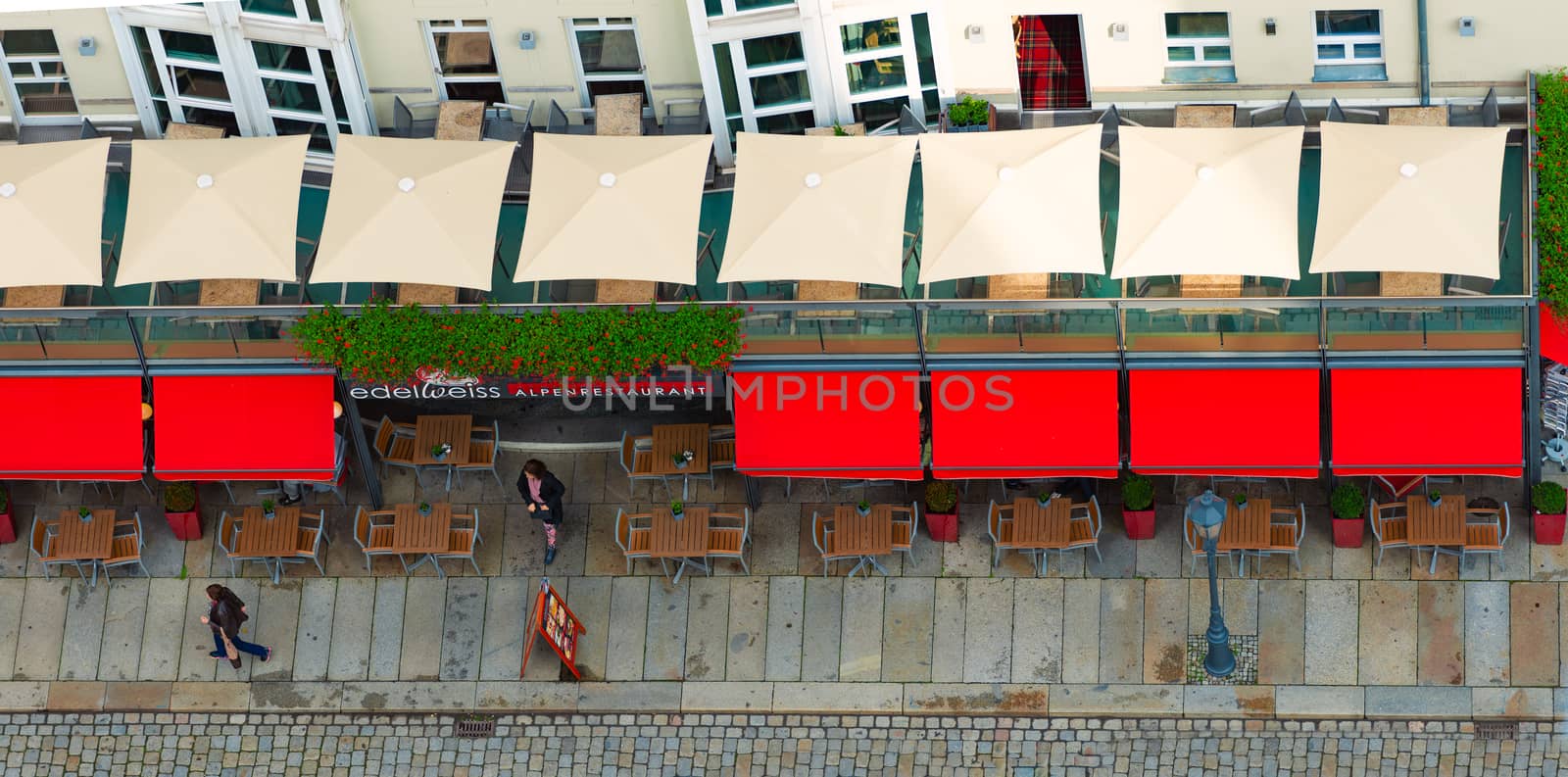 DRESDEN, GERMANY - SEPTEMBER 22, 2014: Top down view on street of Dresden, state of Saxony, Germany, Europe. Restaurant and people down below.