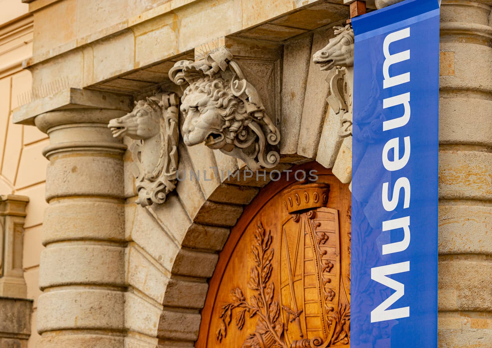 Old museum building in Dresden, Germany, Europe. Horse and lion heads above wooden door entrance.