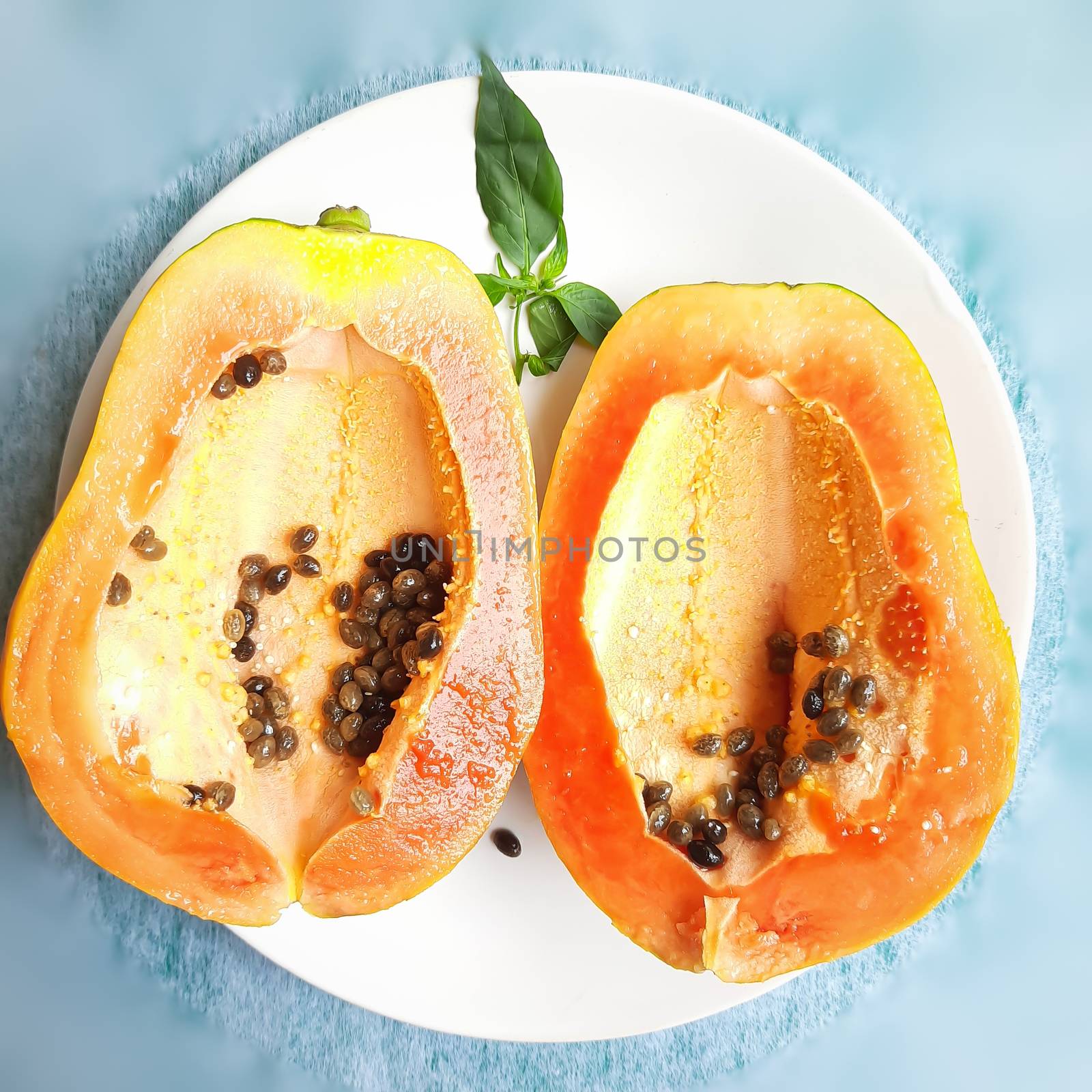 Orange color fresh papaya cut into half kept in white background and rich in fibre Vitamin C and antioxidants Boosts your immunity Good for diabetics and eyes
