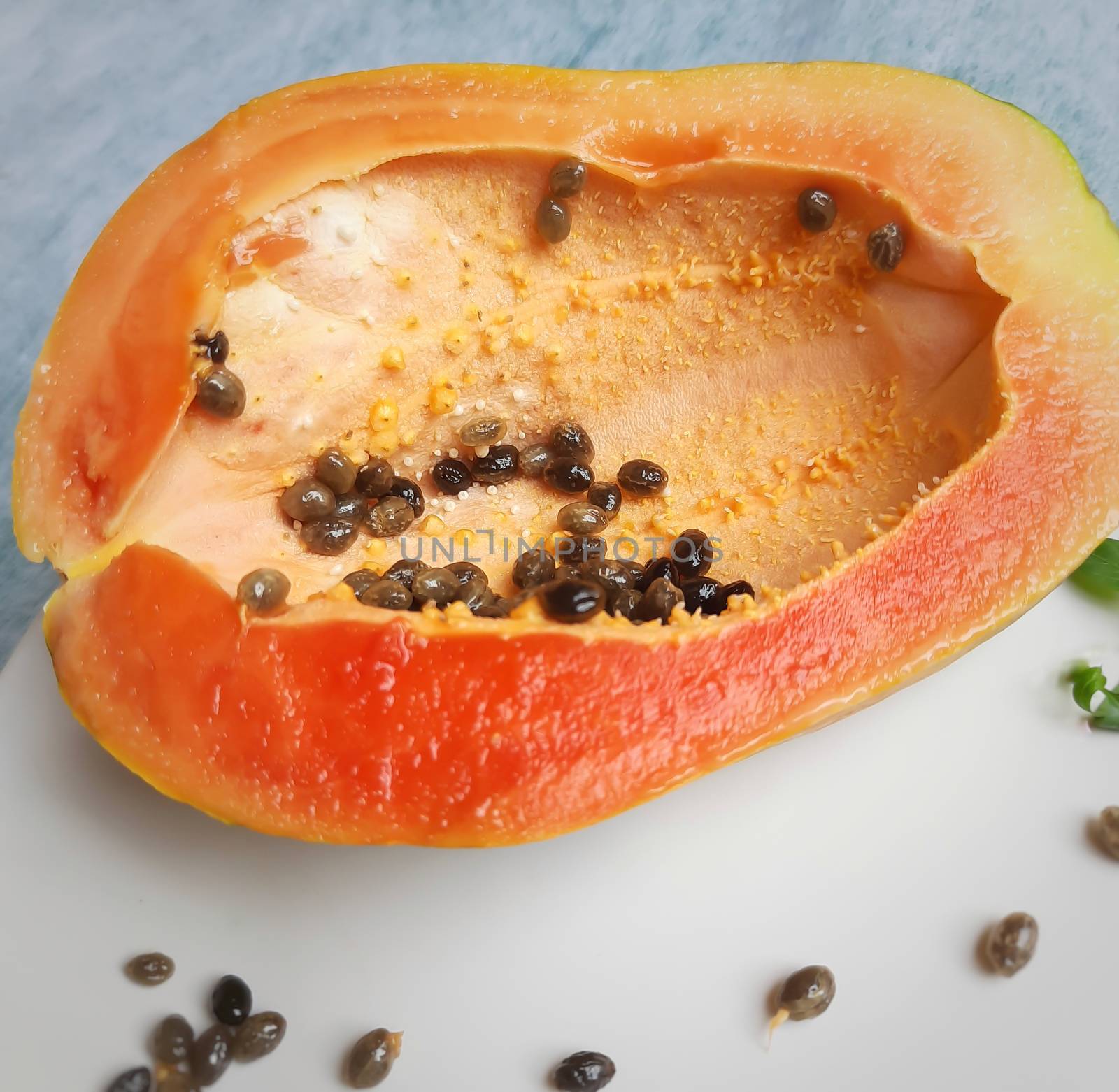 Orange color fresh papaya cut into half kept in white background and rich in fibre Vitamin C and antioxidants Boosts your immunity Good for diabetics and eyes