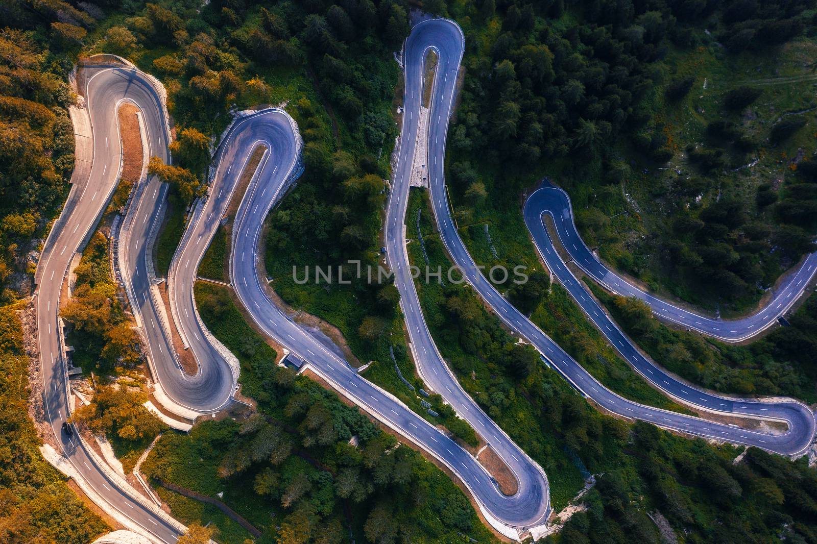 Aerial view of Maloja Pass road in Switzerland. This Swiss Alps mountain road is located in dense forests of the canton Graubunden.