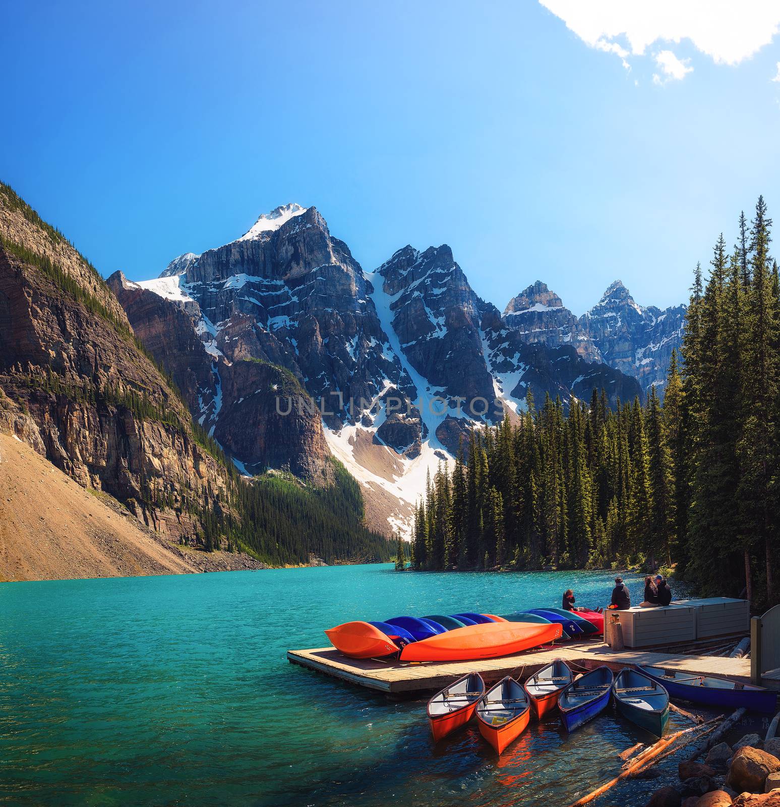 Canoes on a jetty at Moraine lake in Canada by nickfox