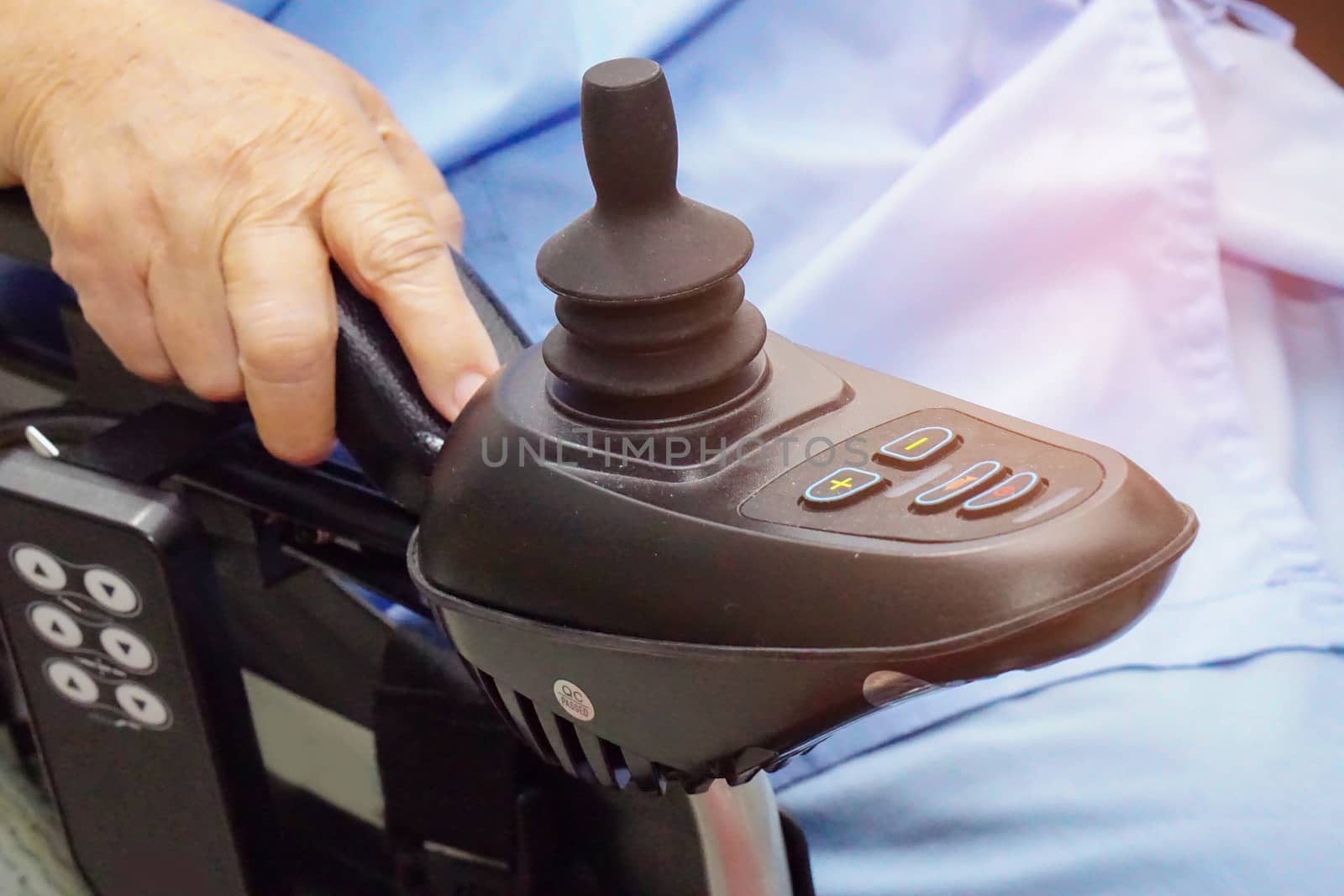 Asian senior or elderly old lady woman patient on electric wheelchair with remote control at nursing hospital ward : healthy strong medical concept