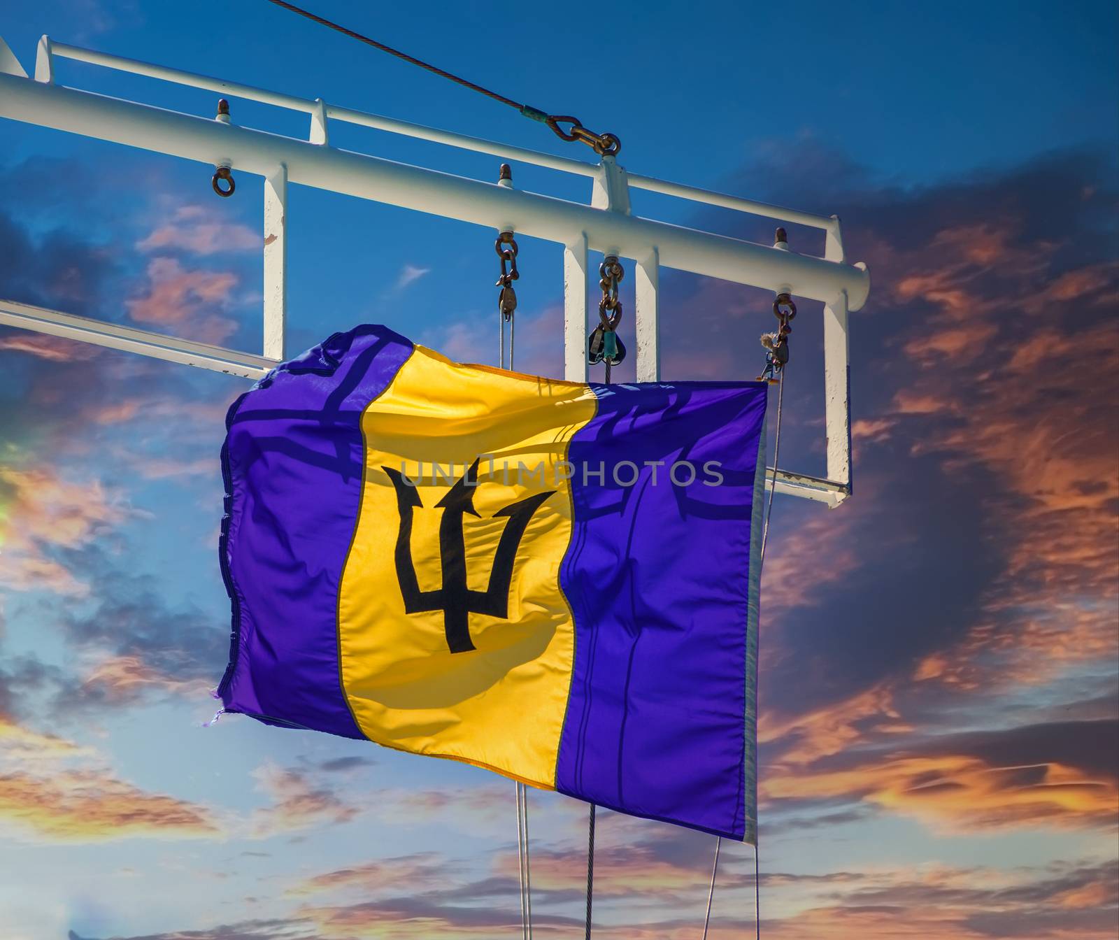 Barbados Flag on a Ship at Sunset  by dbvirago