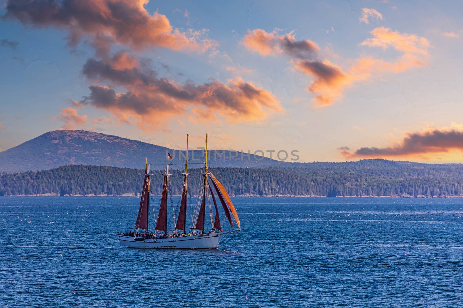 A four-masted schooner sailing across the harbor near Bar Harbor, Maine